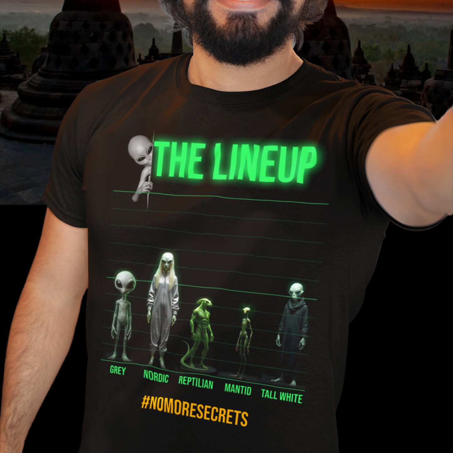 Alien Races Lineup T-shirt in Black, front print, worn by a model (temple at sunset). AI-edited photo: the real print artwork was digitally placed on a model photo.