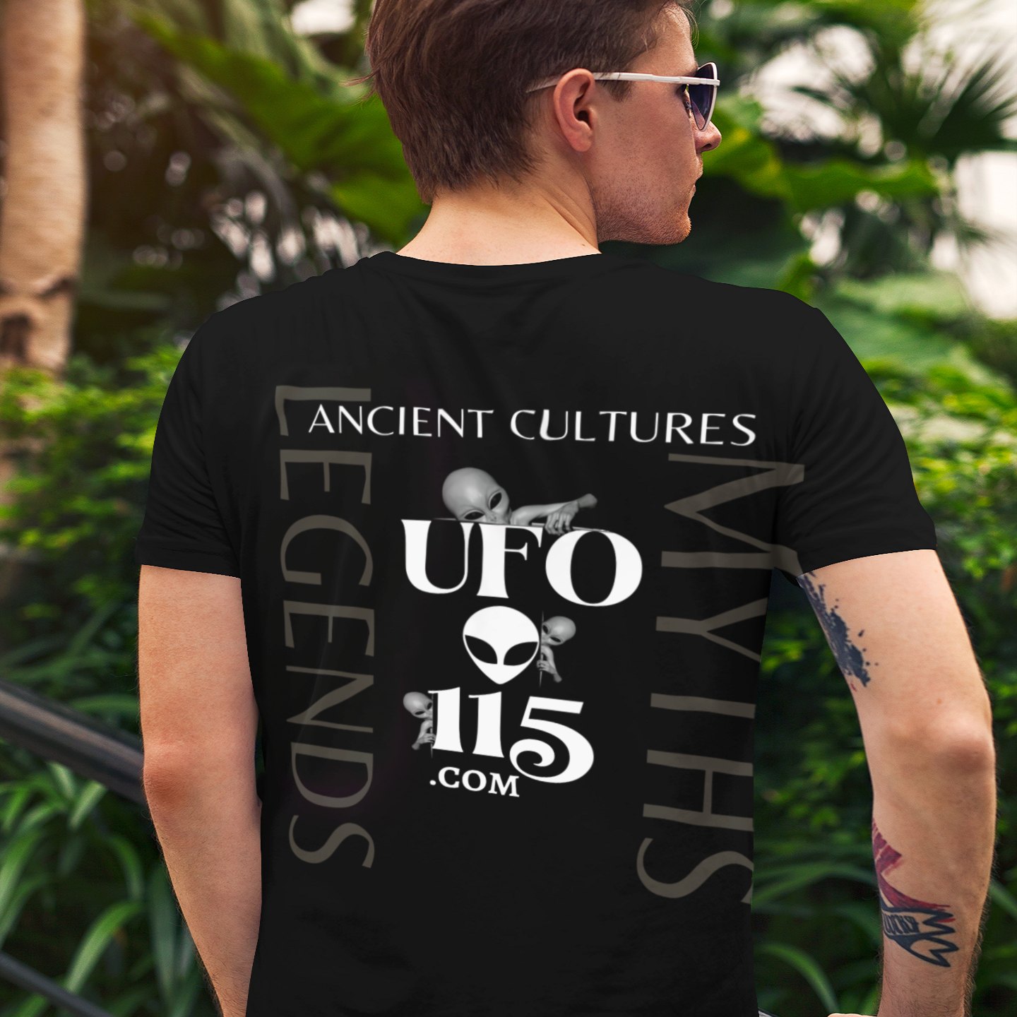 Ancient Thai Secrets T-shirt in Black, back print, worn by a model (tropical garden, day (back)). AI-edited photo: the real print artwork was digitally placed on a model photo.