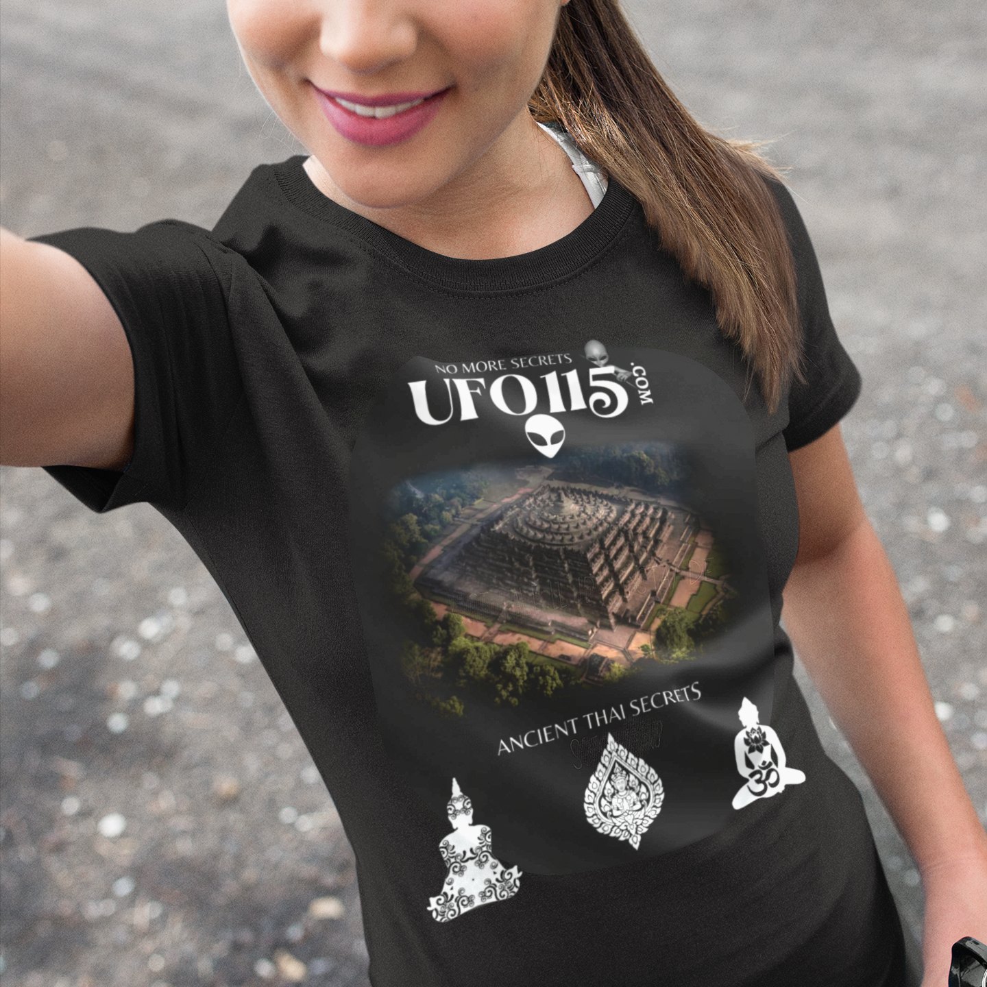 Ancient Thai Secrets T-shirt in Black, front print, worn by a model (outdoor selfie, day). AI-edited photo: the real print artwork was digitally placed on a model photo.