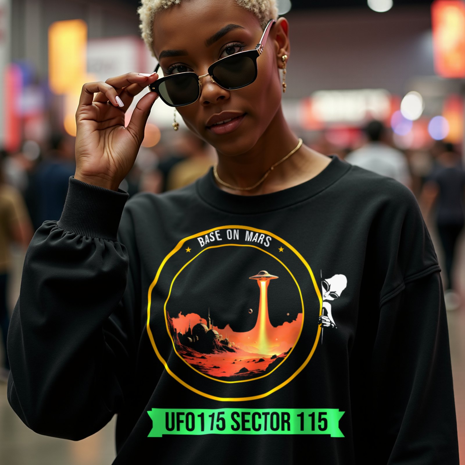 Base on Mars Mission Patch crewneck sweatshirt in Black, worn by a model (in a busy science-fiction fan convention hall). AI-generated image: model and scene are AI-generated; the print is the real artwork.