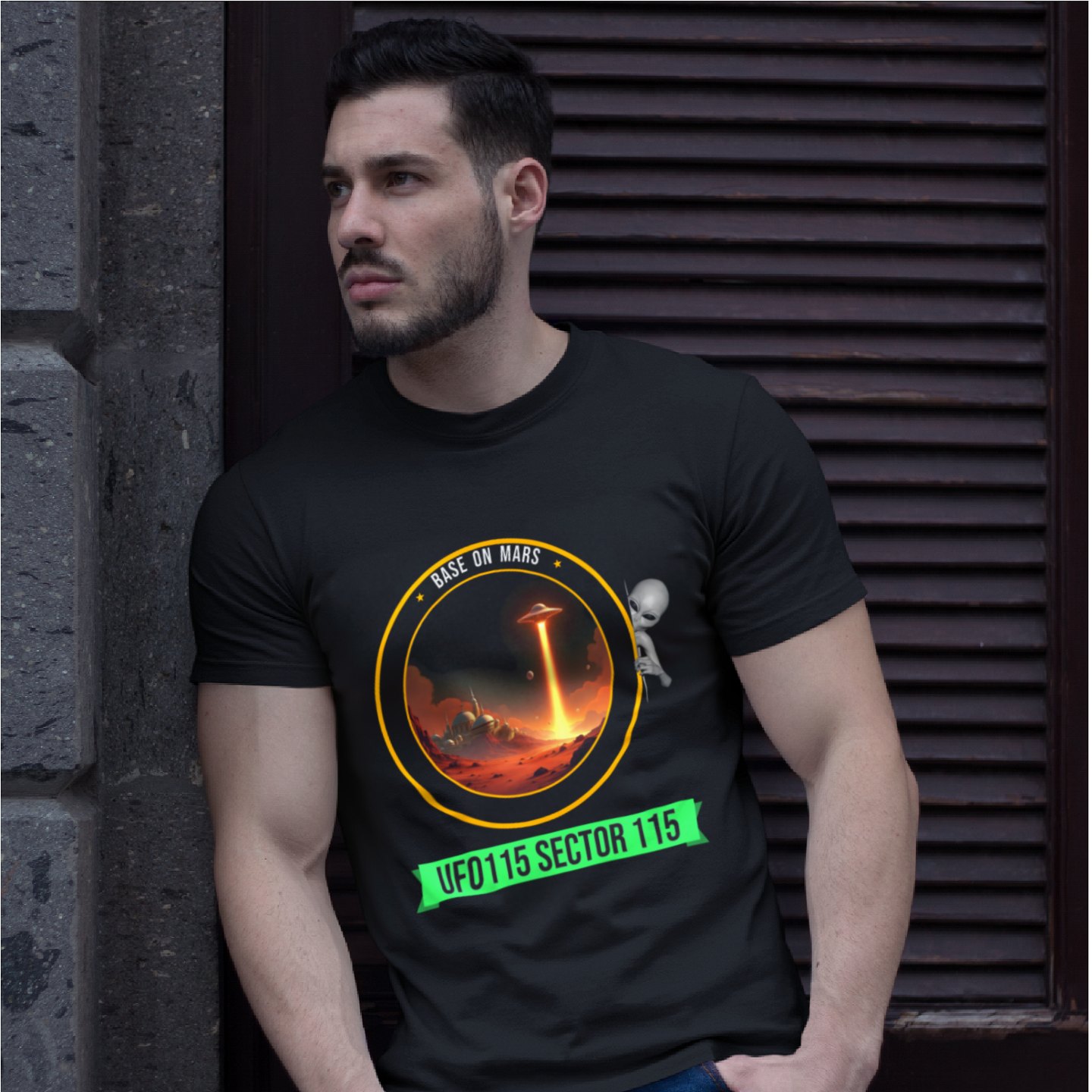 Base on Mars Mission Patch T-shirt in Black, front print, worn by a model (stone doorway, day). AI-edited photo: the real print artwork was digitally placed on a model photo.