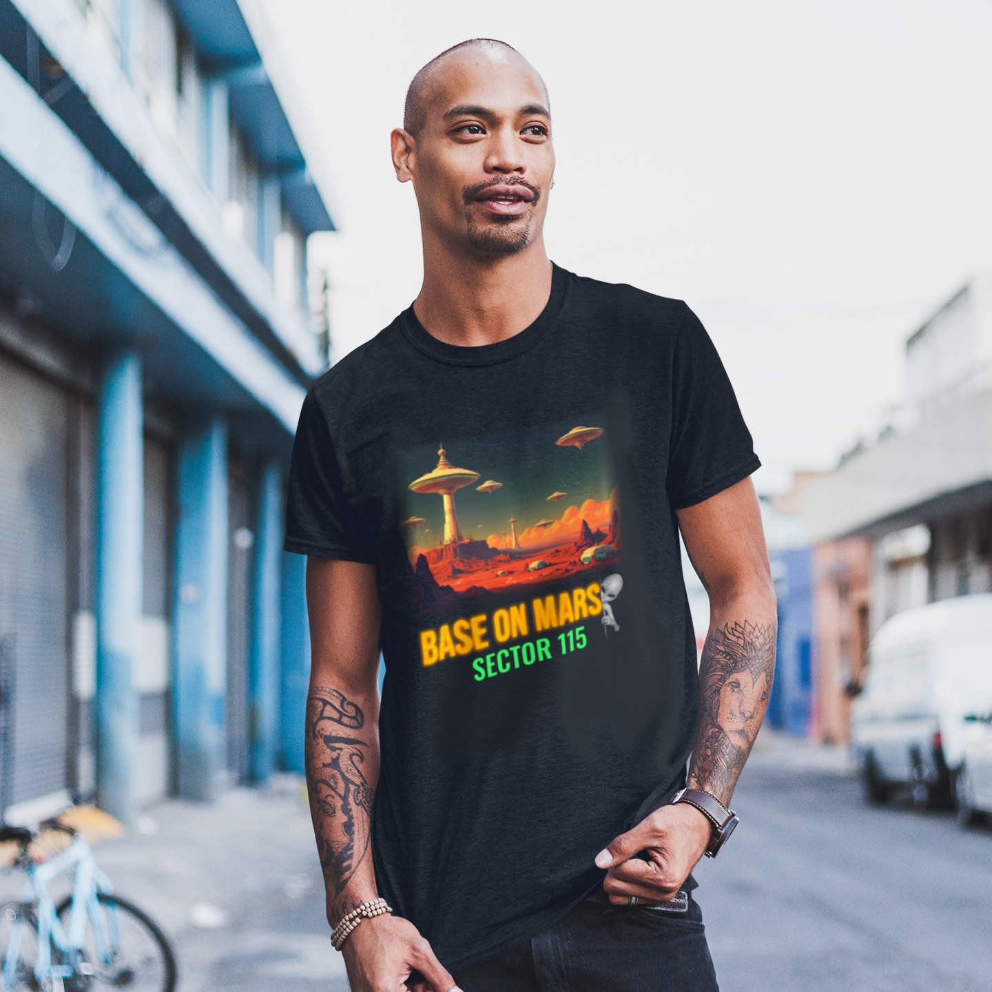 Base on Mars Retro T-shirt in Black, front print, worn by a model (city street, day). AI-edited photo: the real print artwork was digitally placed on a model photo.