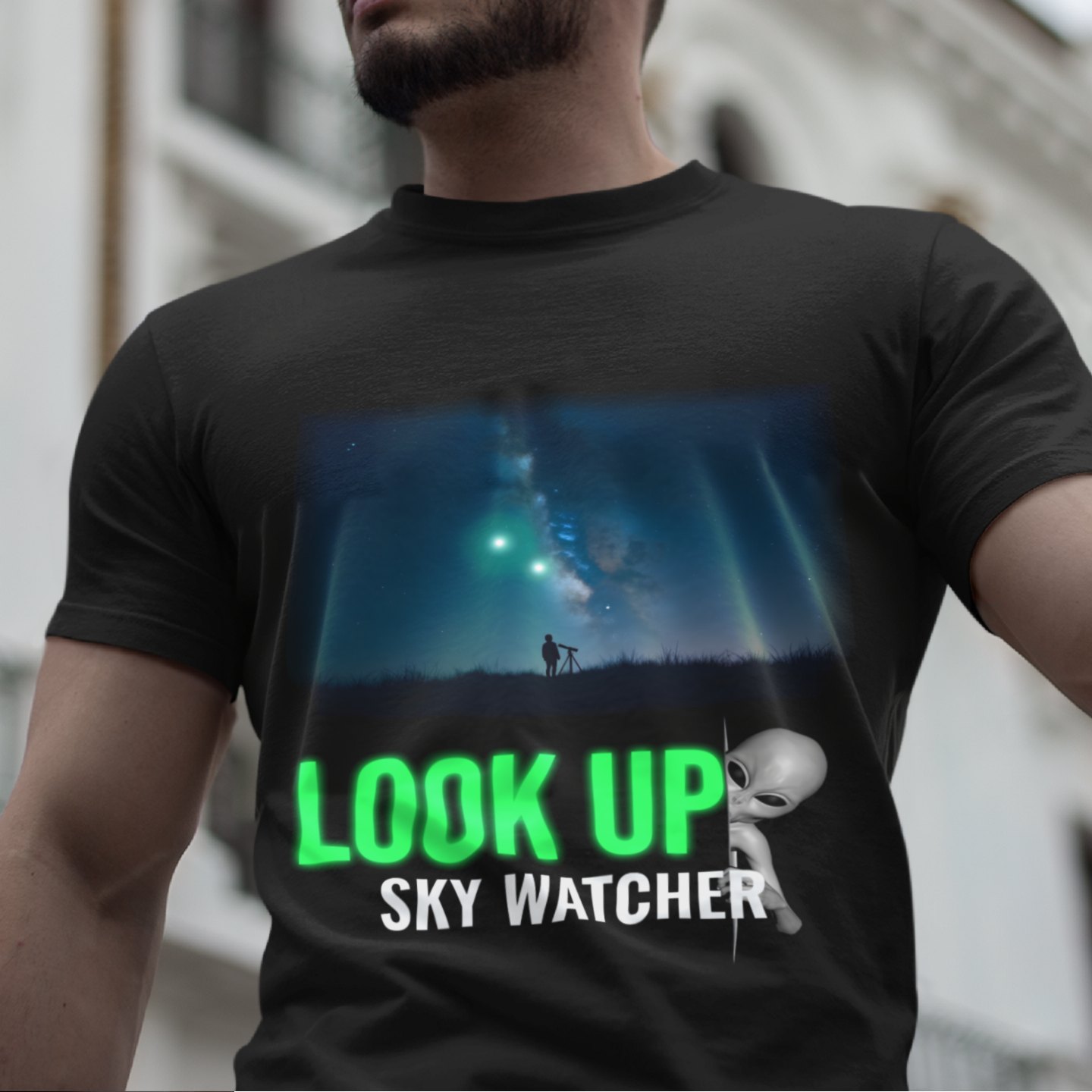 Look Up Sky Watcher T-shirt in Black, front print, worn by a model (classic architecture, day). AI-edited photo: the real print artwork was digitally placed on a model photo.