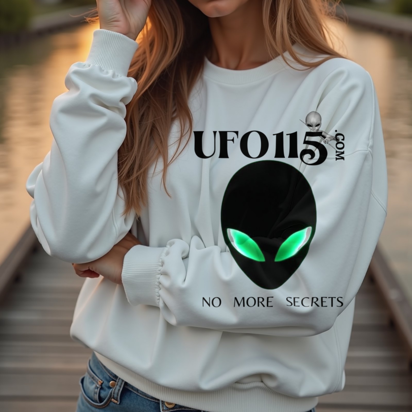 No More Secrets Green Eyes crewneck sweatshirt in White, worn by a model (on a wooden boardwalk by a tropical lagoon at sunset). AI-generated image: model and scene are AI-generated; the print is the real artwork.