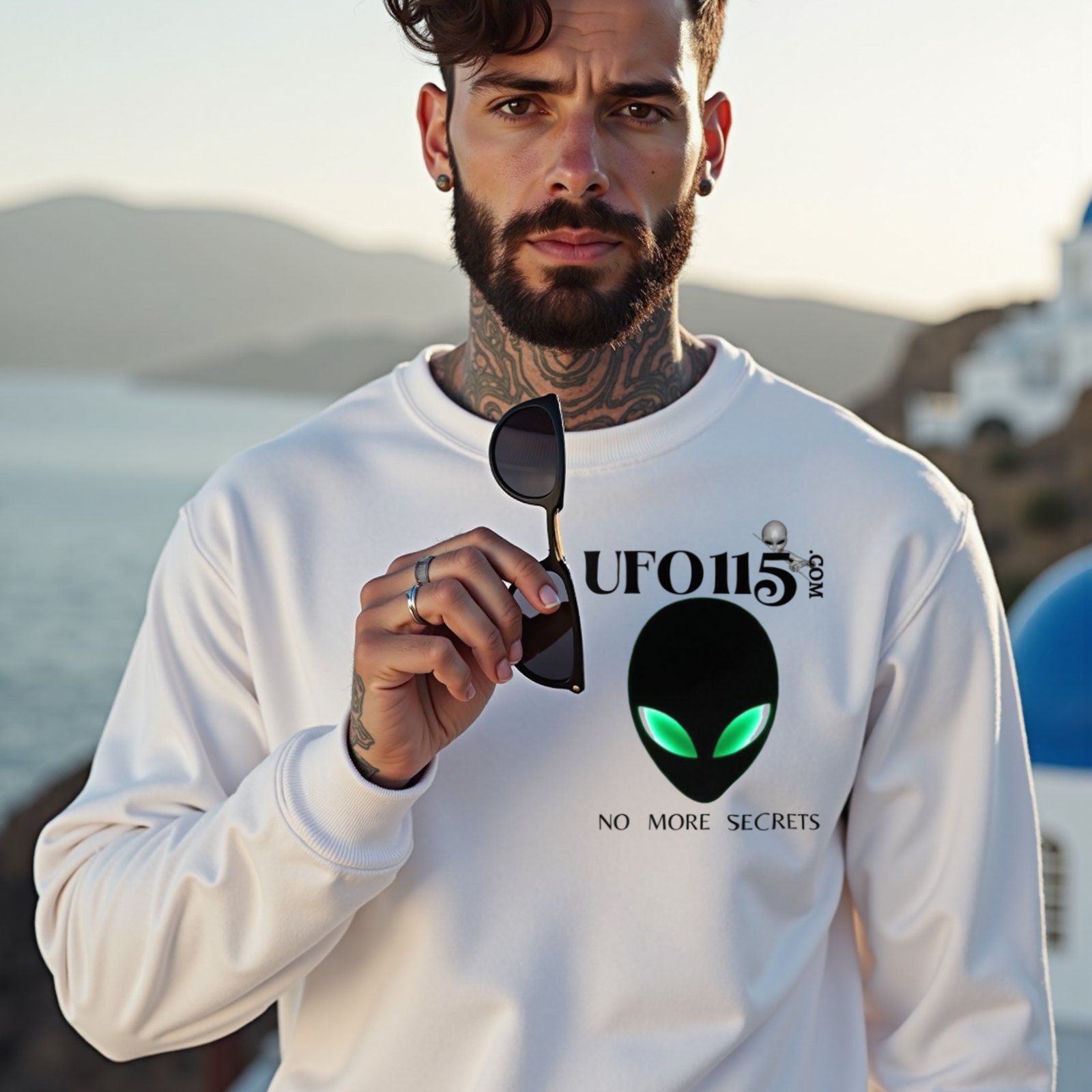 No More Secrets Green Eyes crewneck sweatshirt in White, worn by a model (on a whitewashed Santorini terrace at golden hour). AI-generated image: model and scene are AI-generated; the print is the real artwork.