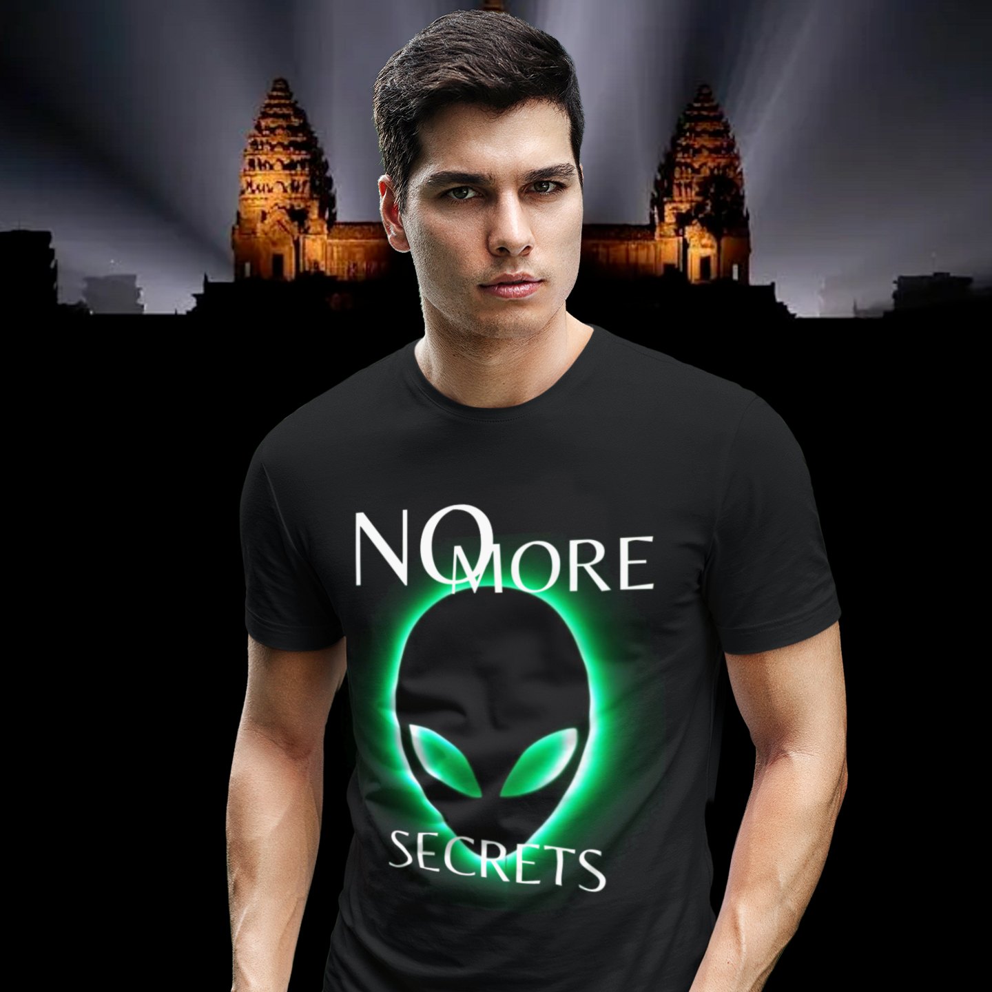 No More Secrets Green Glow Alien Face T-shirt in Black, front print, worn by a model (Angkor temple light beams). AI-edited photo: the real print artwork was digitally placed on a model photo.