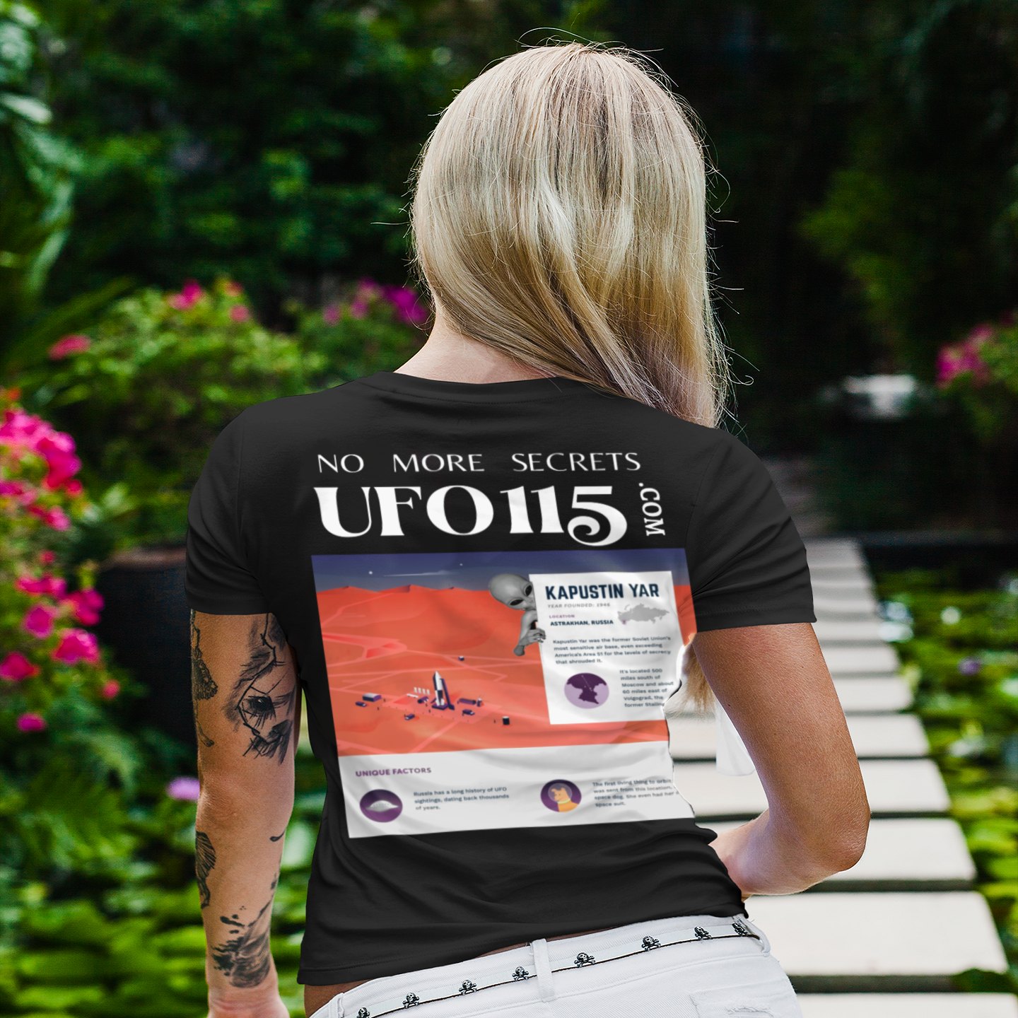 No More Secrets Kapustin Yar T-shirt in Black, back print, worn by a model (tropical garden walkway (back)). AI-edited photo: the real print artwork was digitally placed on a model photo.