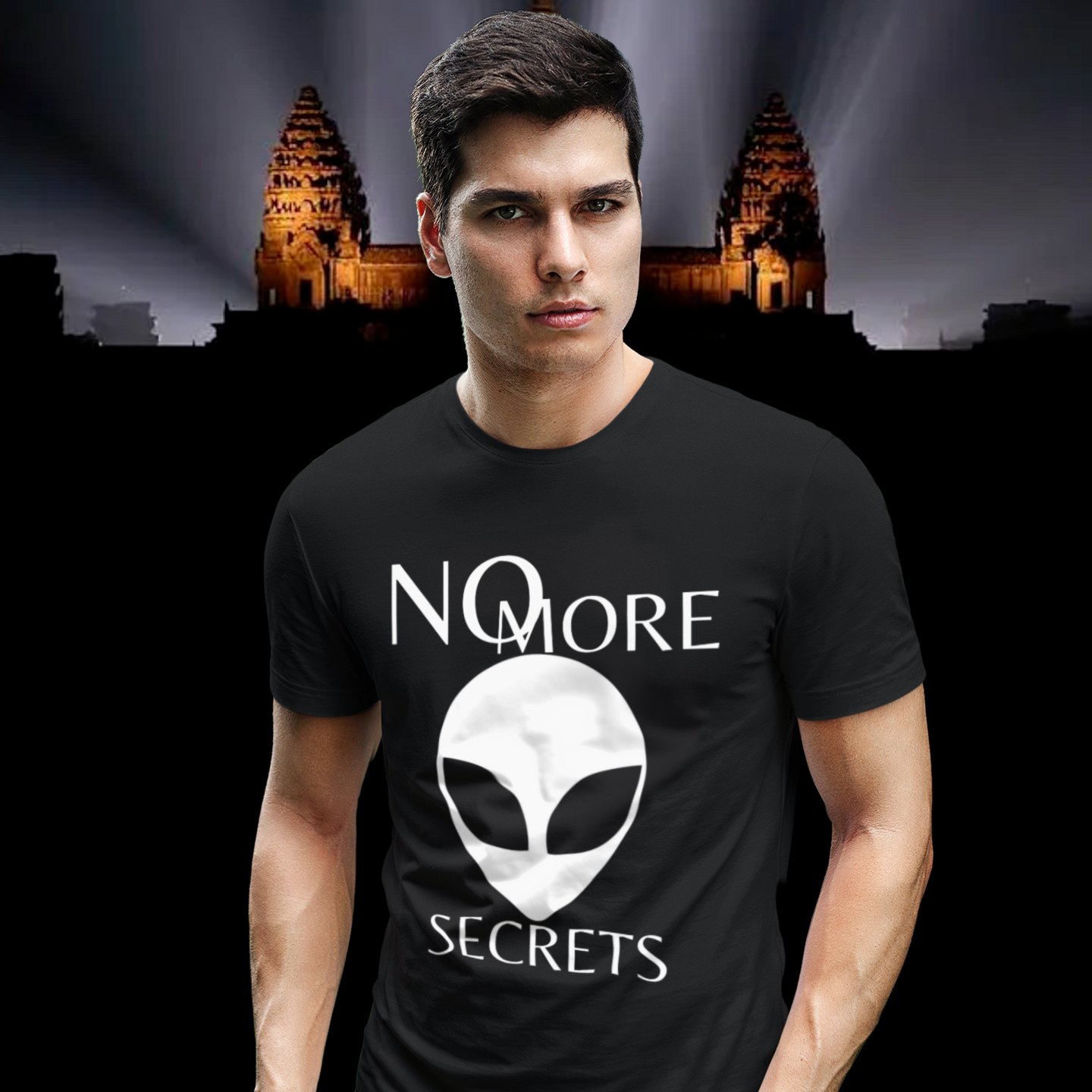 No More Secrets Pine Gap T-shirt in Black, front print, worn by a model (Angkor temple light beams). AI-edited photo: the real print artwork was digitally placed on a model photo.