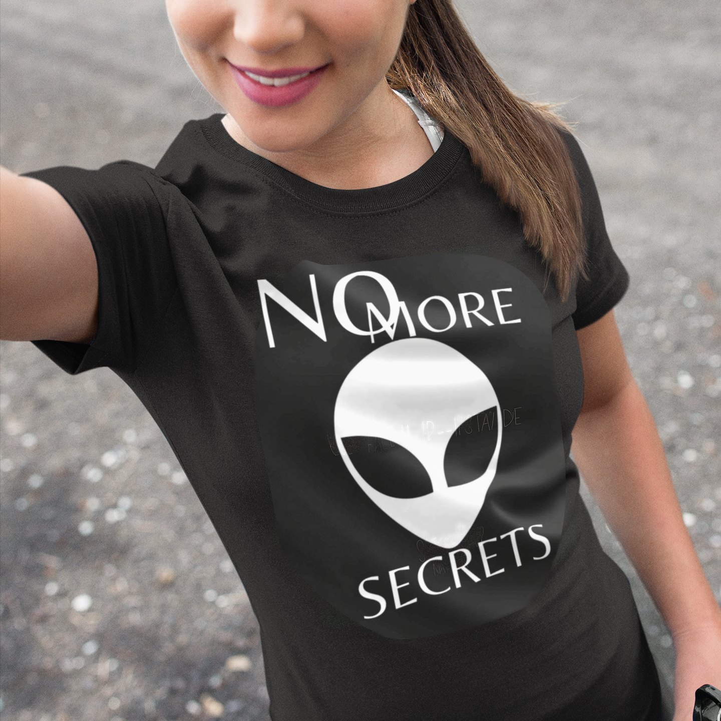 No More Secrets Pine Gap T-shirt in Black, front print, worn by a model (outdoor selfie, day). AI-edited photo: the real print artwork was digitally placed on a model photo.