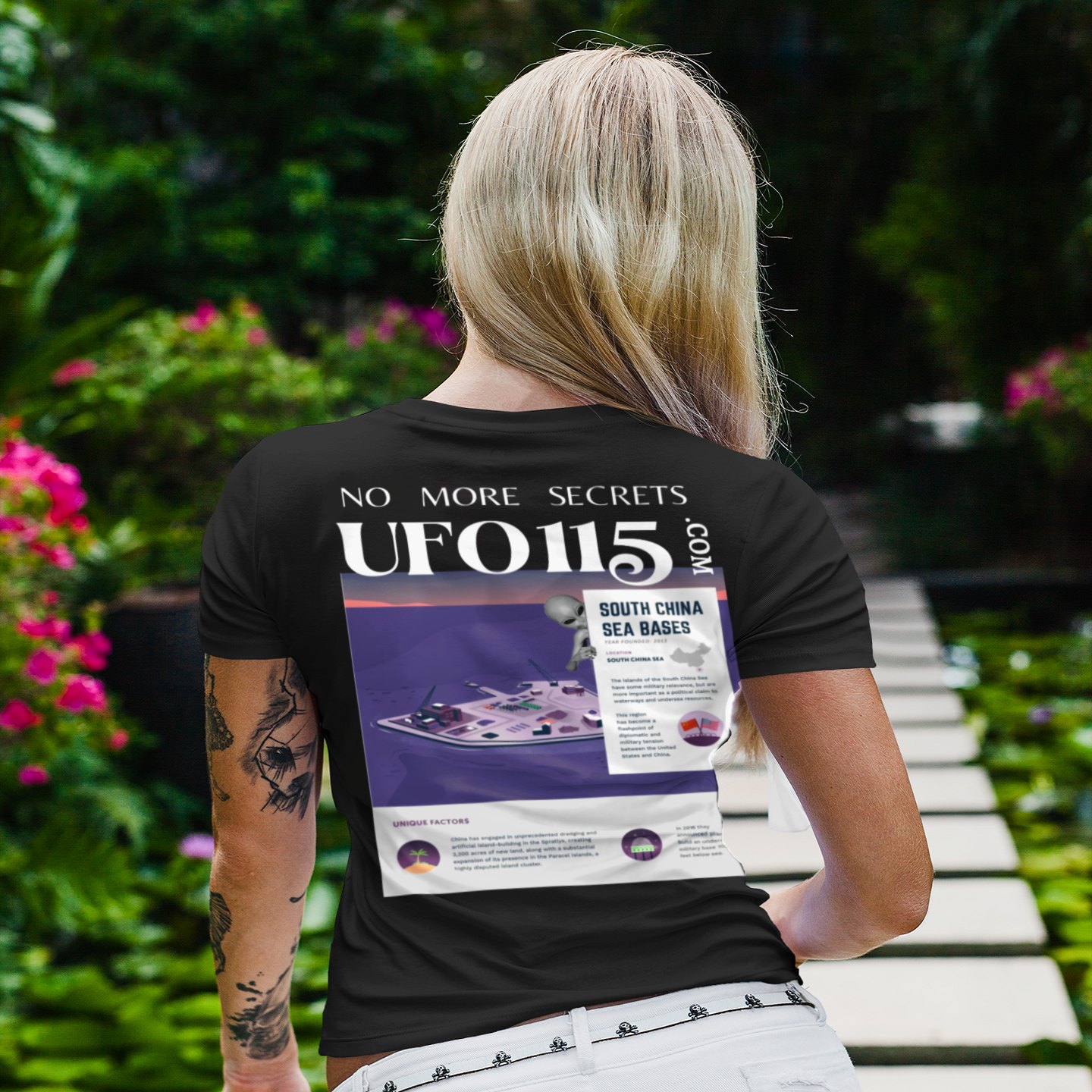 No More Secrets South China Sea T-shirt in Black, back print, worn by a model (tropical garden walkway (back)). AI-edited photo: the real print artwork was digitally placed on a model photo.