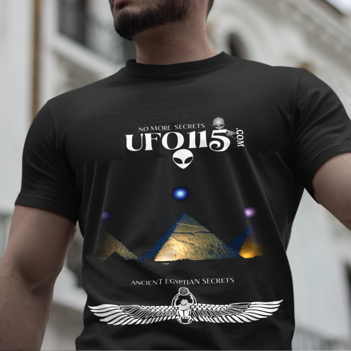 Orion's Belt Pyramids T-shirt in Black, front print, worn by a model (classic architecture, day). AI-edited photo: the real print artwork was digitally placed on a model photo.