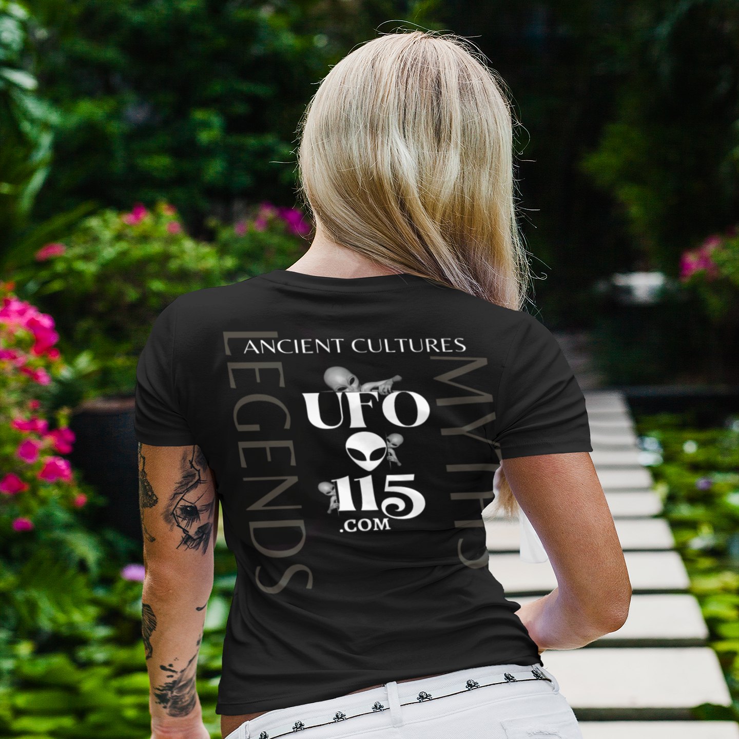 Orion's Belt Pyramids T-shirt in Black, back print, worn by a model (tropical garden walkway (back)). AI-edited photo: the real print artwork was digitally placed on a model photo.
