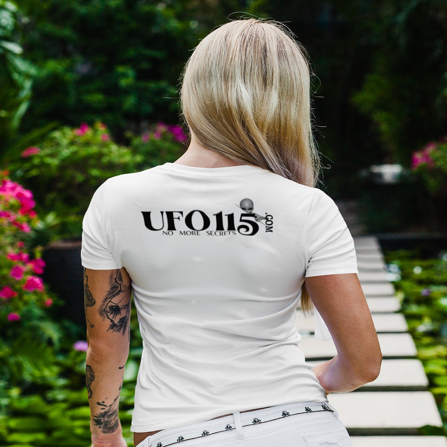 S4 ID Valiant Thor T-shirt in White, back print, worn by a model (tropical garden walkway (back)). AI-edited photo: the real print artwork was digitally placed on a model photo.
