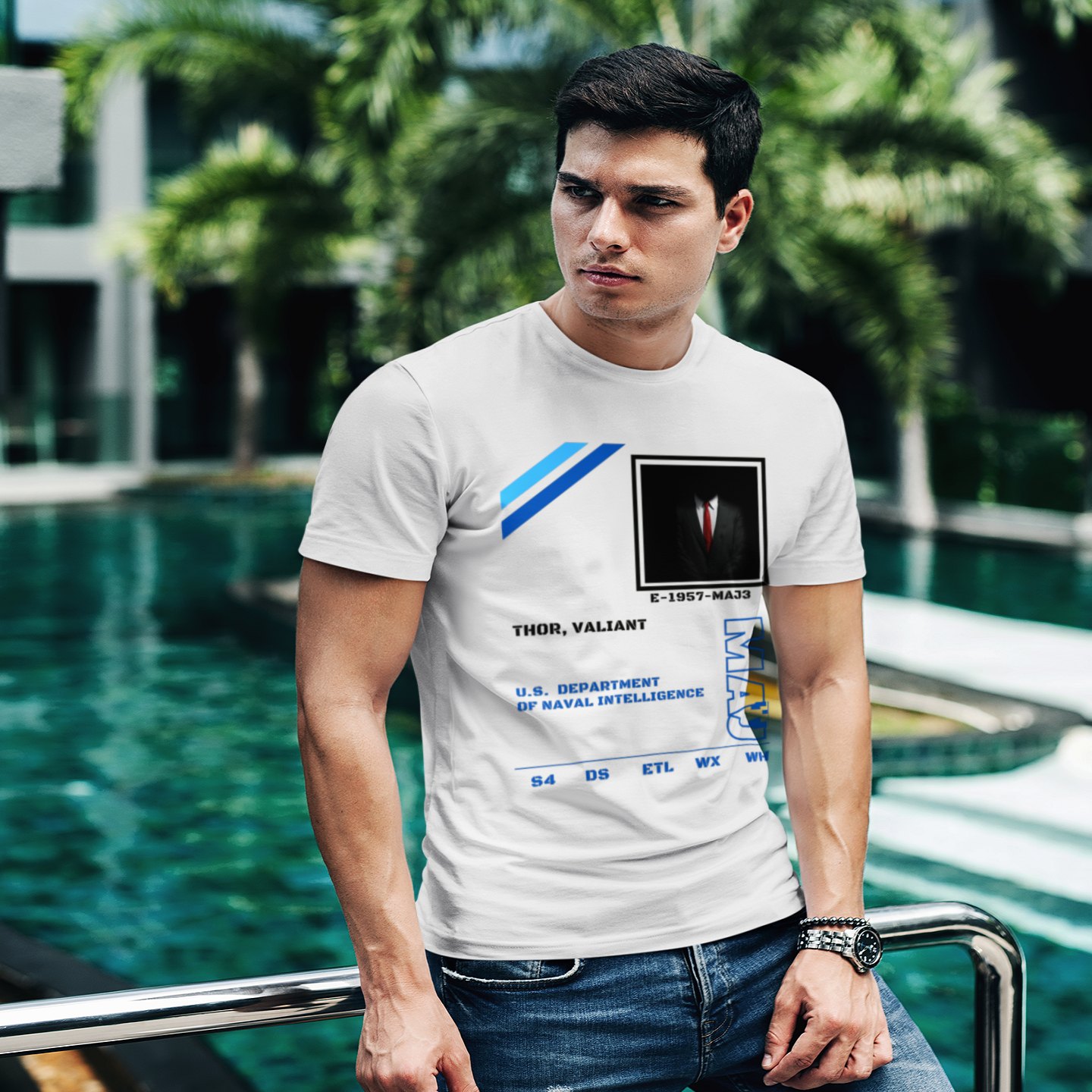 S4 ID Valiant Thor T-shirt in White, front print, worn by a model (tropical pool, day). AI-edited photo: the real print artwork was digitally placed on a model photo.
