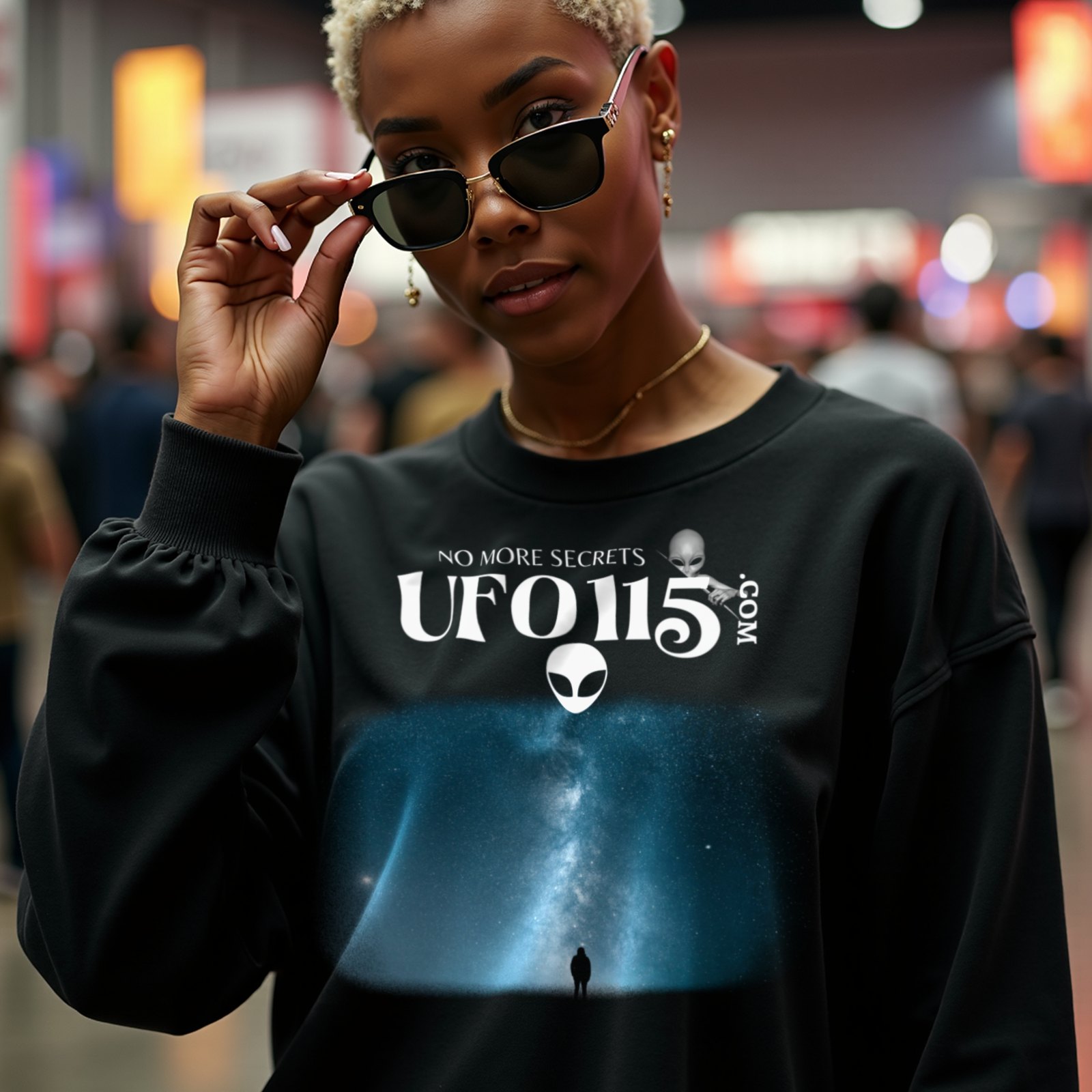 Sky Watcher Blue Solitude crewneck sweatshirt in Black, worn by a model (in a busy science-fiction fan convention hall). AI-generated image: model and scene are AI-generated; the print is the real artwork.