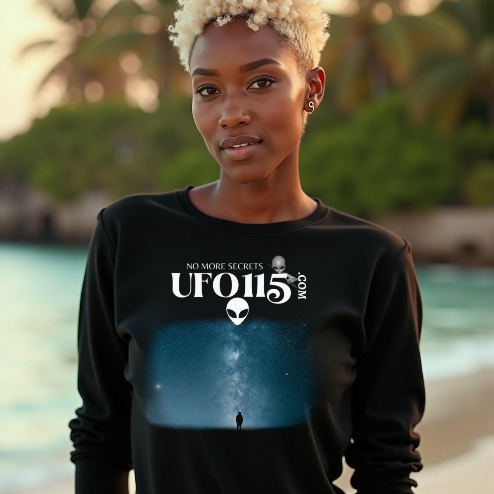Sky Watcher Blue Solitude long-sleeve T-shirt in Black, worn by a model (on a tropical beach at golden hour). AI-generated image: model and scene are AI-generated; the print is the real artwork.