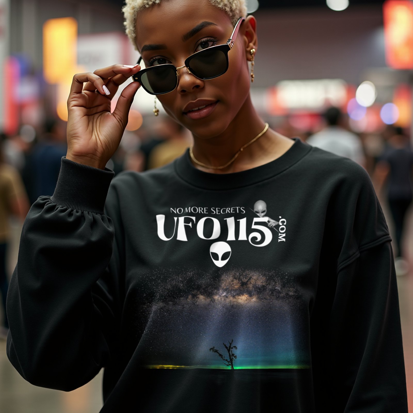Sky Watcher Glowy Nights crewneck sweatshirt in Black, worn by a model (in a busy science-fiction fan convention hall). AI-generated image: model and scene are AI-generated; the print is the real artwork.