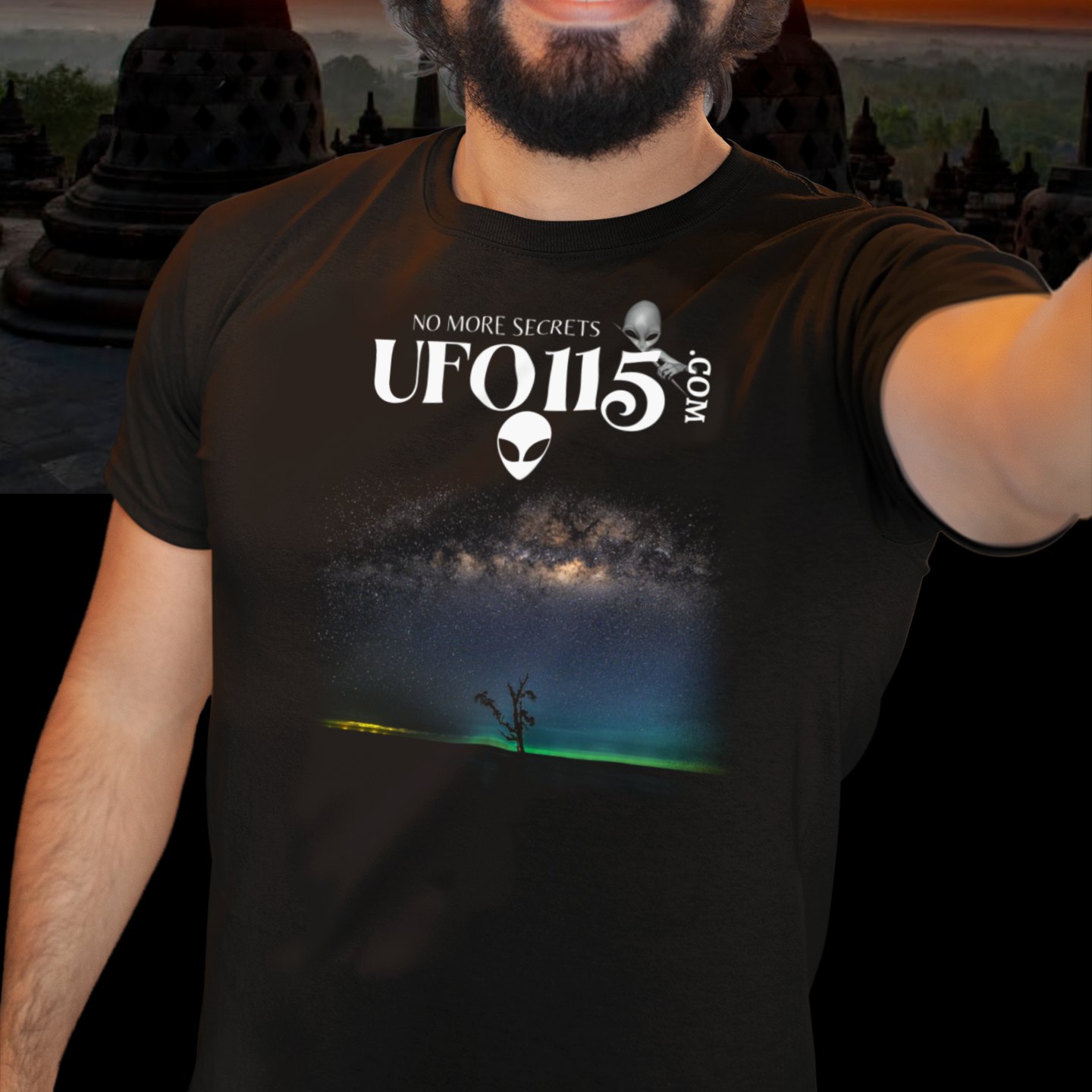 Sky Watcher Glowy Nights T-shirt in Black, front print, worn by a model (temple at sunset). AI-edited photo: the real print artwork was digitally placed on a model photo.