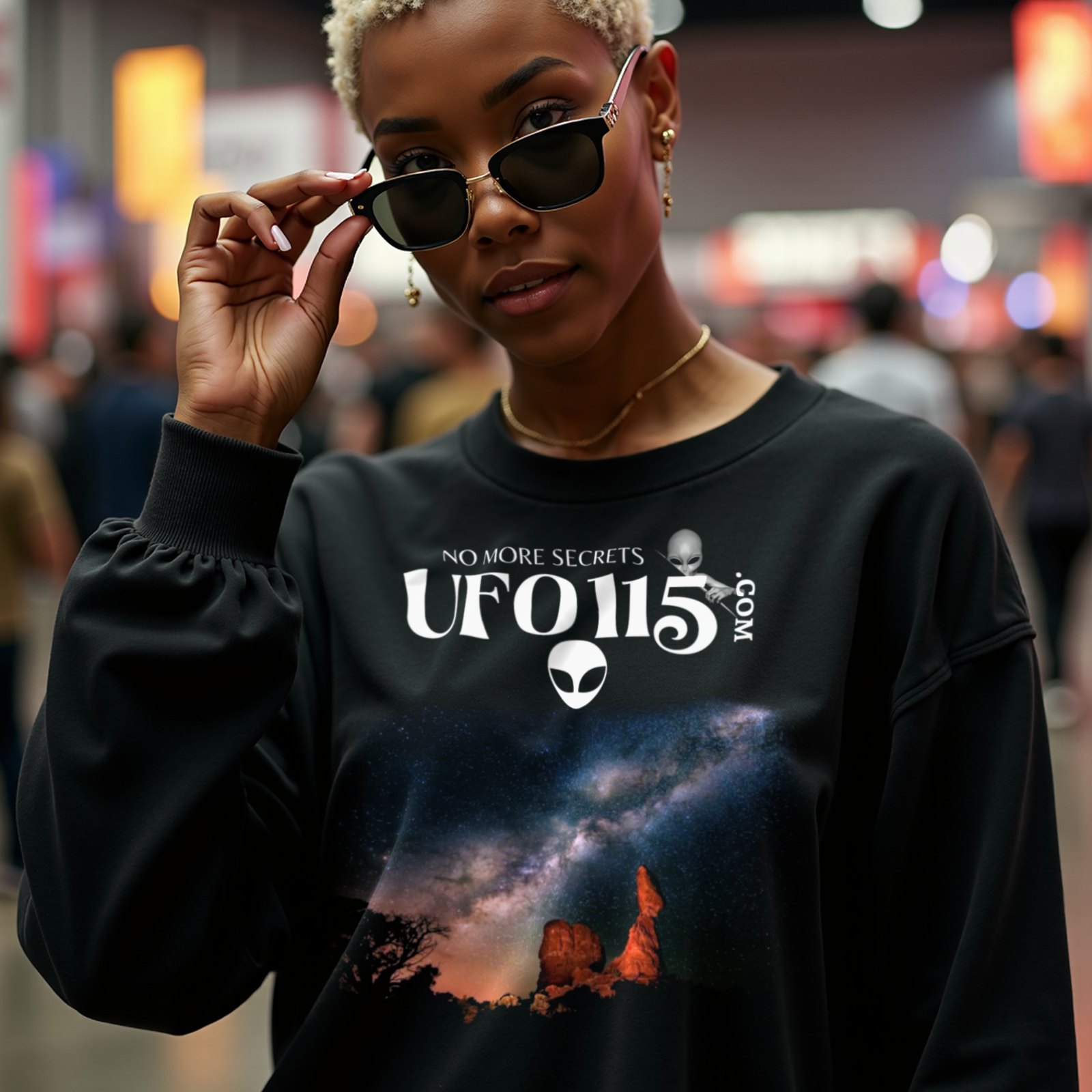 Sky Watcher Milky Way Canyon crewneck sweatshirt in Black, worn by a model (in a busy science-fiction fan convention hall). AI-generated image: model and scene are AI-generated; the print is the real artwork.