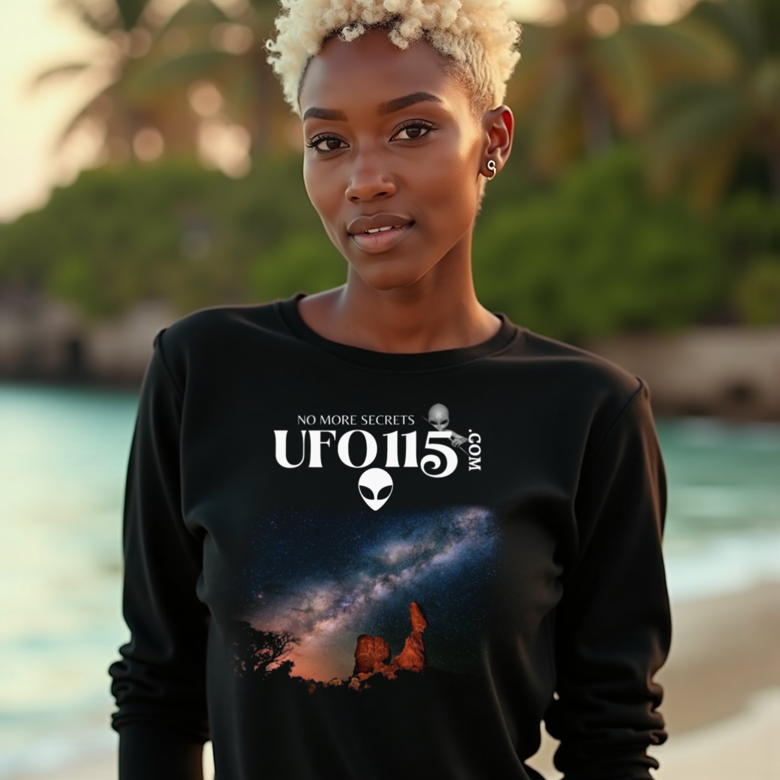 Sky Watcher Milky Way Canyon long-sleeve T-shirt in Black, worn by a model (on a tropical beach at golden hour). AI-generated image: model and scene are AI-generated; the print is the real artwork.