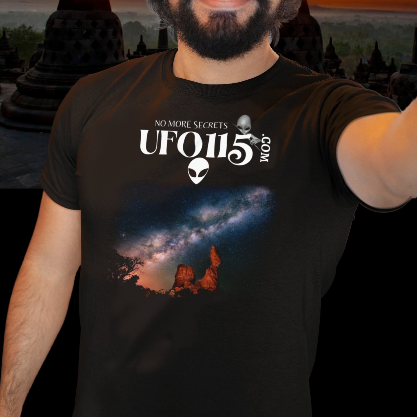 Sky Watcher Milky Way Canyon T-shirt in Black, front print, worn by a model (temple at sunset). AI-edited photo: the real print artwork was digitally placed on a model photo.