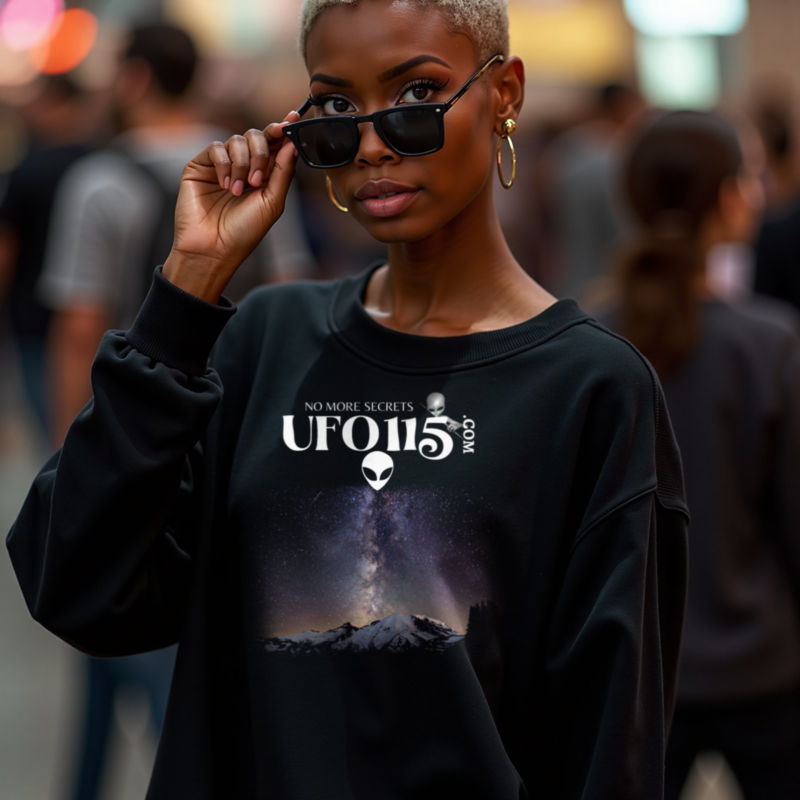 Sky Watcher Mountain Light crewneck sweatshirt in Black, worn by a model (in a busy science-fiction fan convention hall). AI-generated image: model and scene are AI-generated; the print is the real artwork.