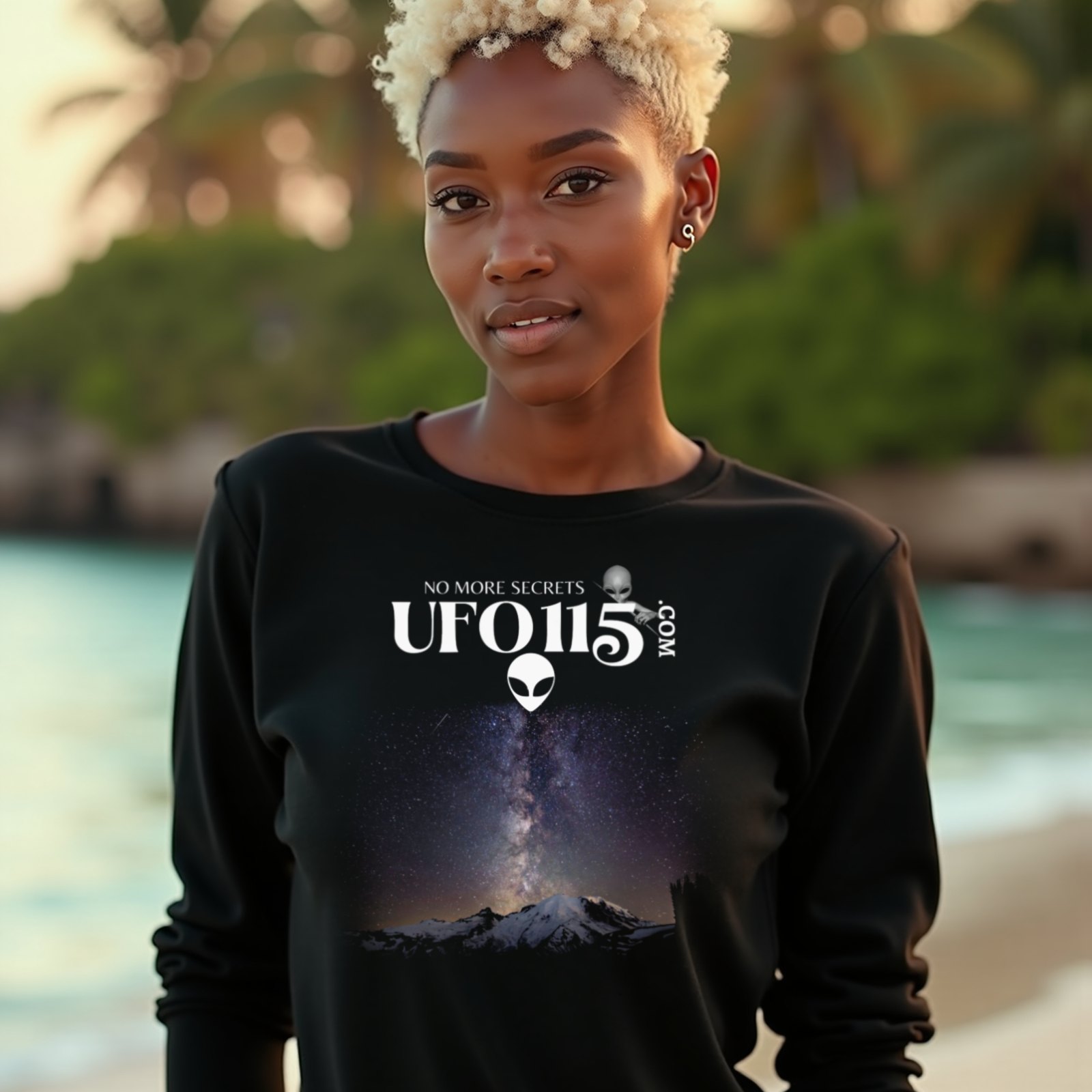 Sky Watcher Mountain Light long-sleeve T-shirt in Black, worn by a model (on a tropical beach at golden hour). AI-generated image: model and scene are AI-generated; the print is the real artwork.