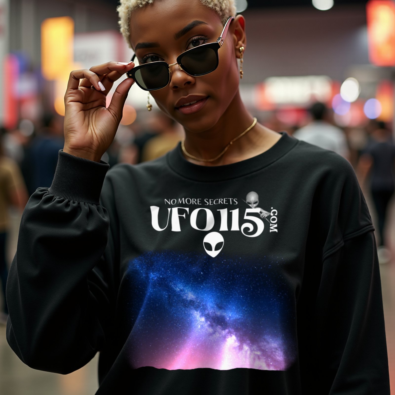Sky Watcher Pretty in Pink crewneck sweatshirt in Black, worn by a model (in a busy science-fiction fan convention hall). AI-generated image: model and scene are AI-generated; the print is the real artwork.