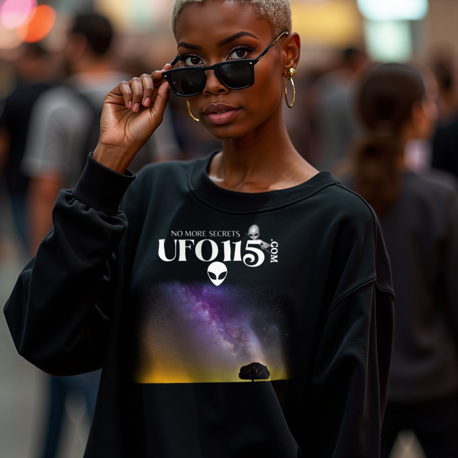 Sky Watcher Purple Star Dust crewneck sweatshirt in Black, worn by a model (in a busy science-fiction fan convention hall). AI-generated image: model and scene are AI-generated; the print is the real artwork.