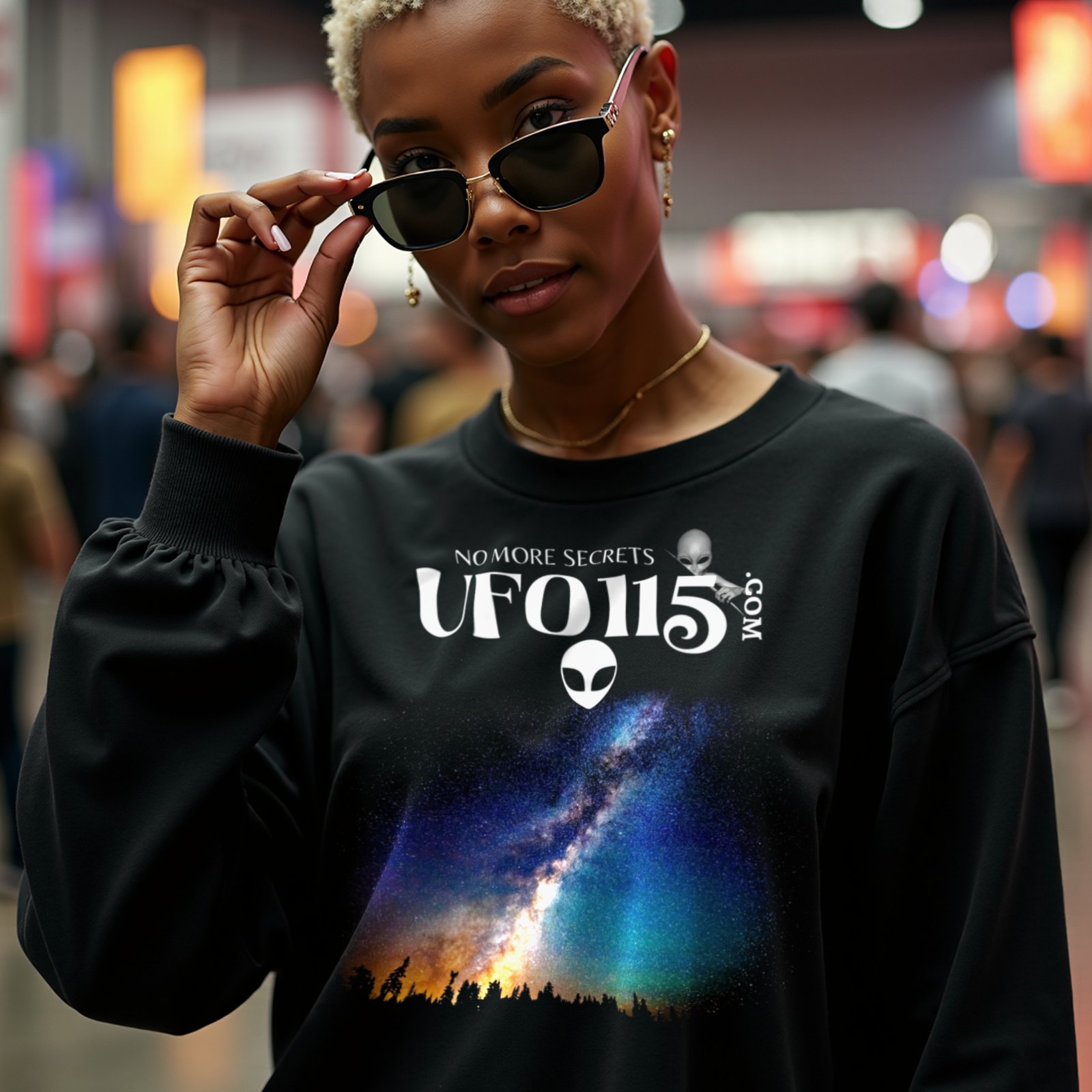 Sky Watcher Rainbow Bridge crewneck sweatshirt in Black, worn by a model (in a busy science-fiction fan convention hall). AI-generated image: model and scene are AI-generated; the print is the real artwork.