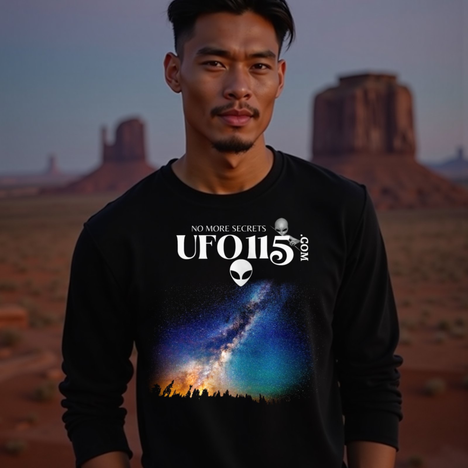 Sky Watcher Rainbow Bridge long-sleeve T-shirt in Black, worn by a model (in Monument Valley at dusk). AI-generated image: model and scene are AI-generated; the print is the real artwork.