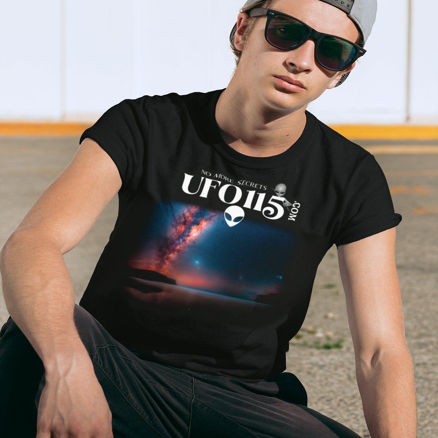Sky Watcher – Ring of Fire T-shirt in Black, front print, worn by a model (urban crouch, day). AI-edited photo: the real print artwork was digitally placed on a model photo.