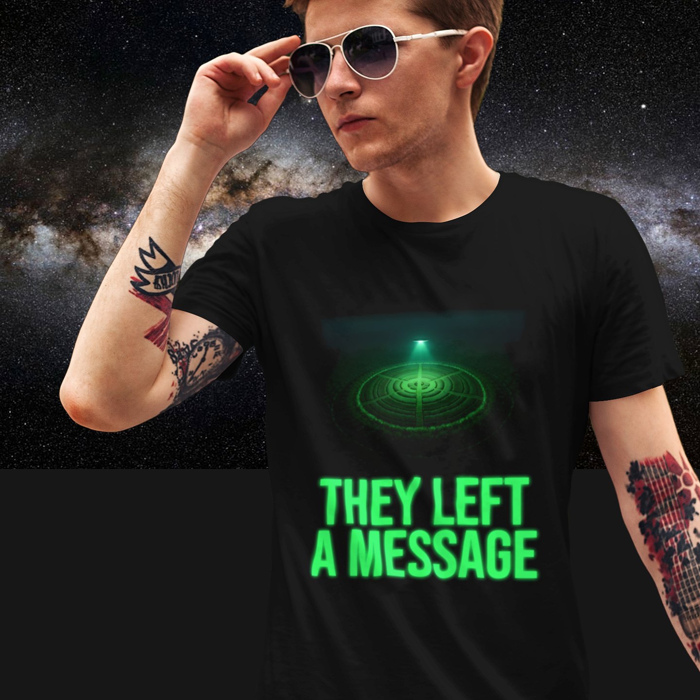 They Left a Message T-shirt in Black, front print, worn by a model (Milky Way night). AI-edited photo: the real print artwork was digitally placed on a model photo.