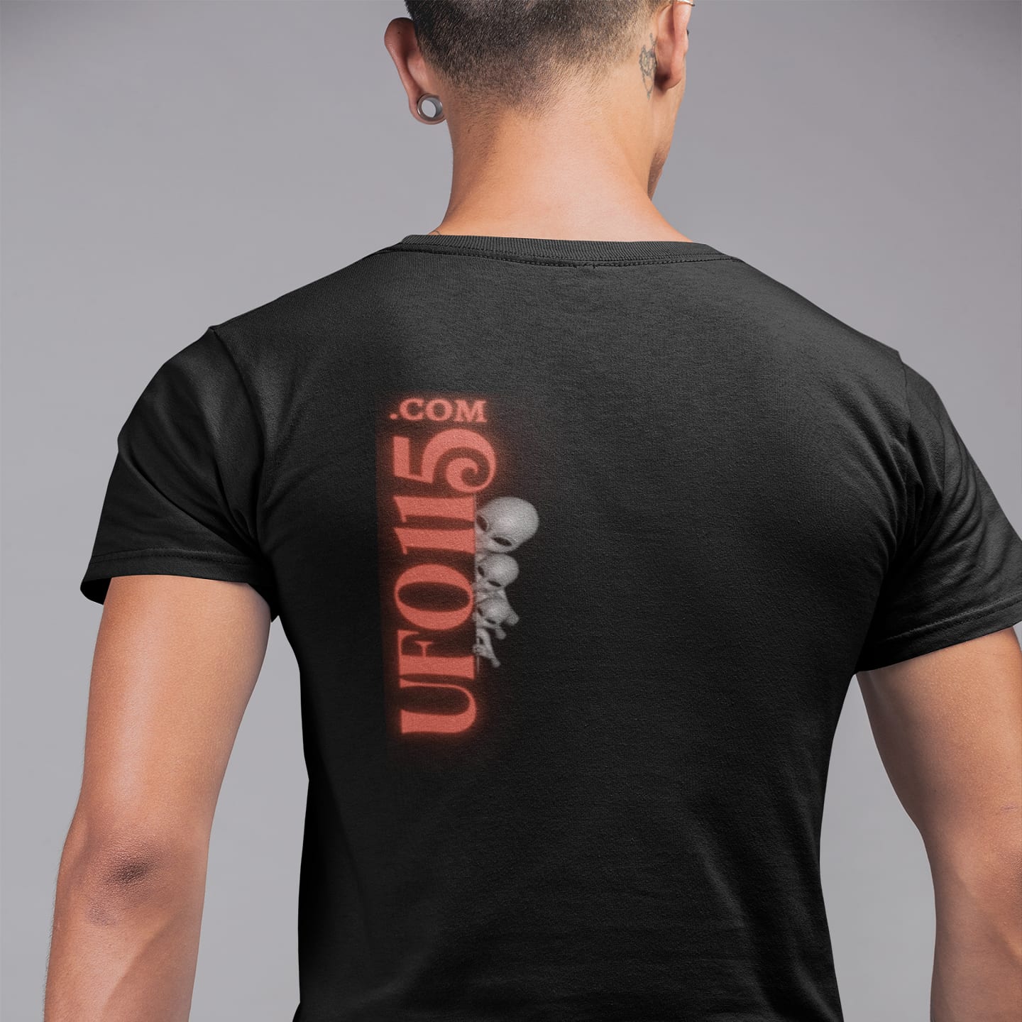 Model wearing the UFO115 Red Angel black T-shirt (back view, UFO115 back print)
