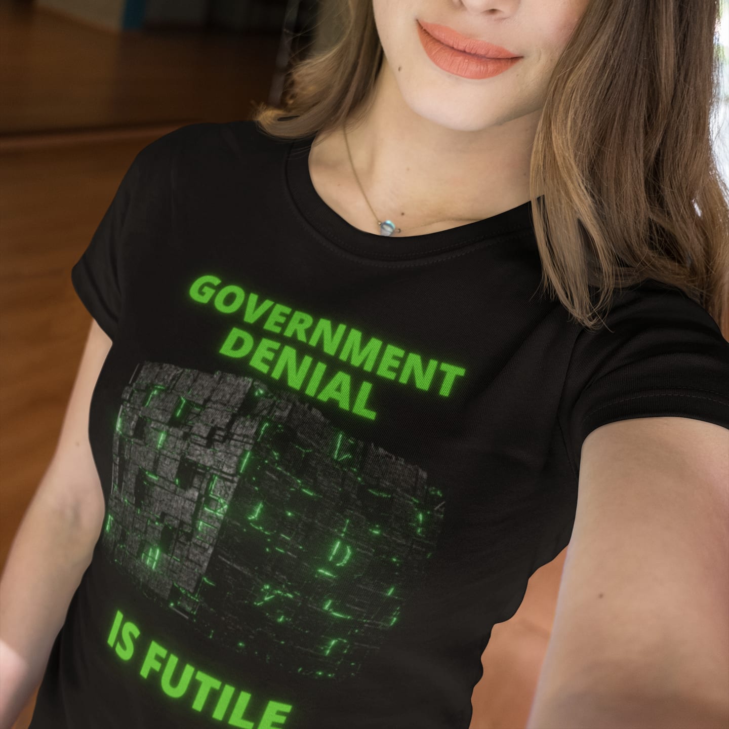Model wearing the Government Denial Is Futile black T-shirt (front view)