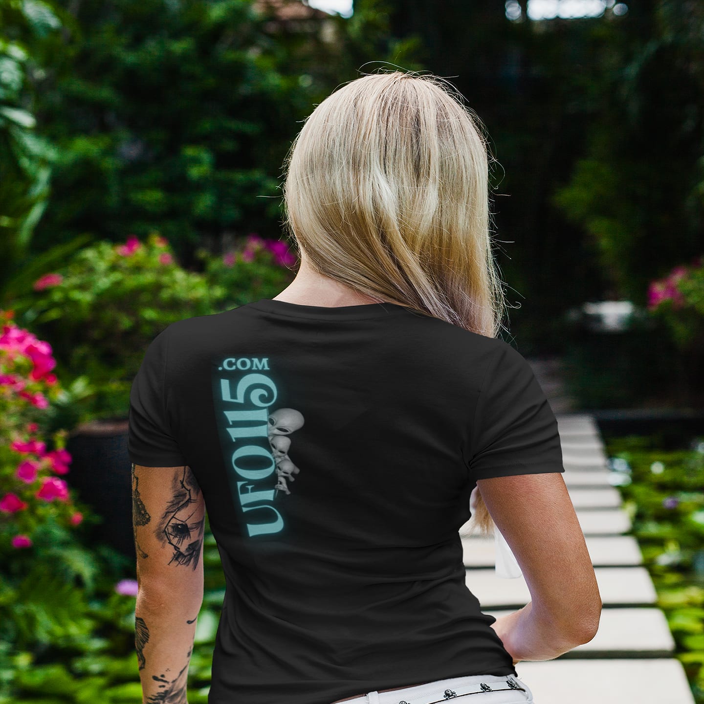 Model wearing the Truth Telling Bob black T-shirt (back view, UFO115 back print)