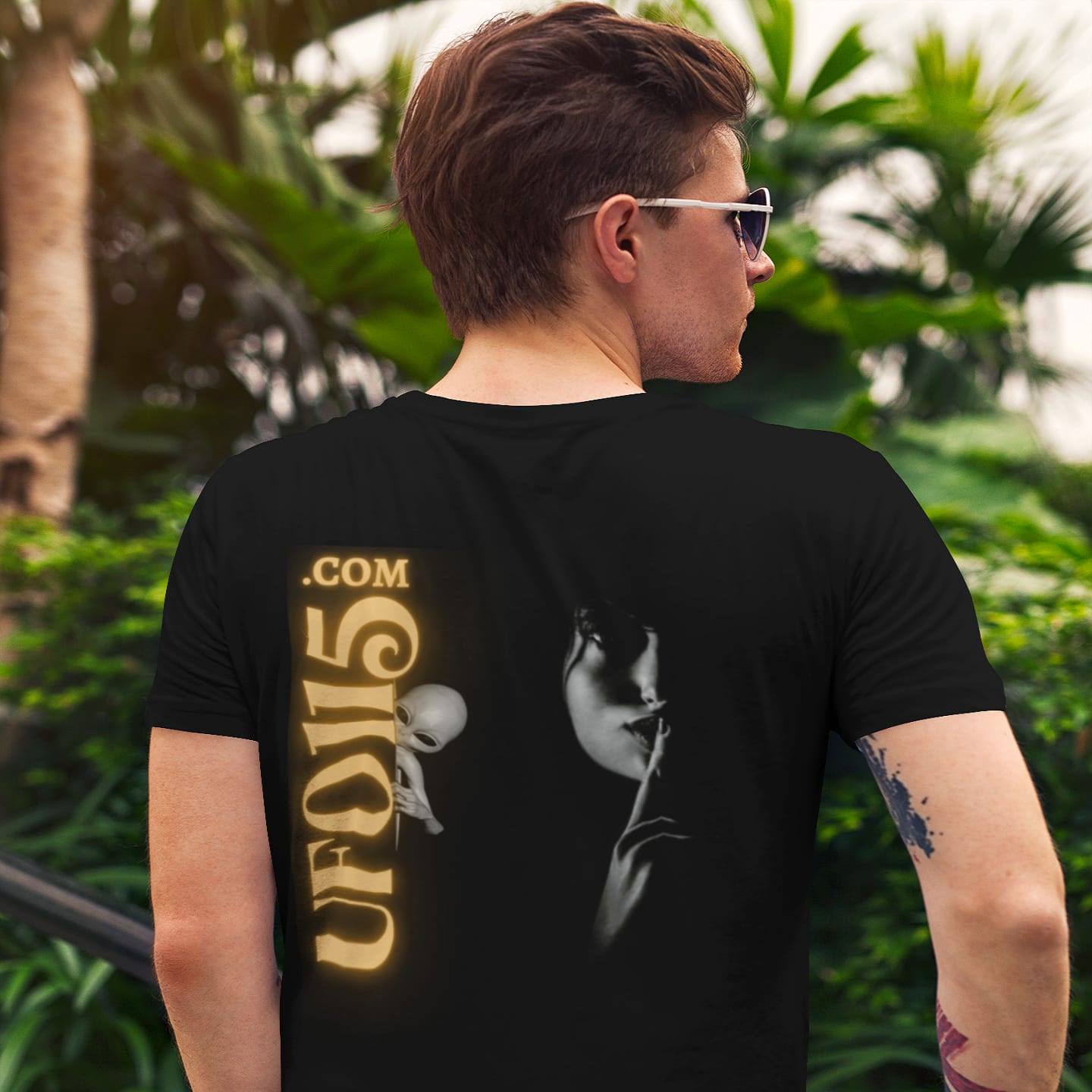 Model wearing the Uup 115 "You Never Saw Me" black T-shirt (back view, UFO115 back print)