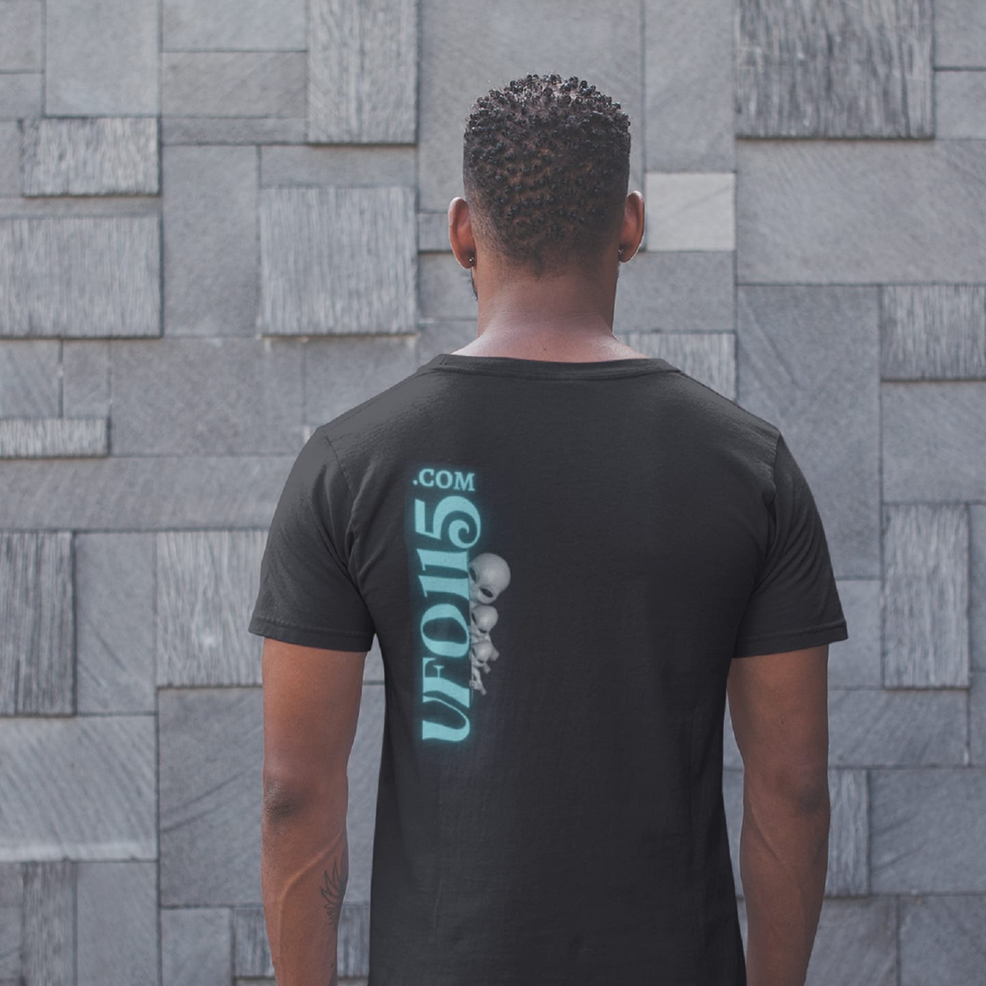Model wearing the Truth Telling Bob black T-shirt (back view, UFO115 back print)