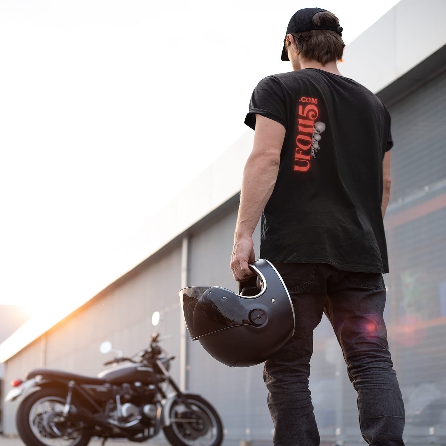 Model wearing the UFO115 Red Angel black T-shirt (back view, UFO115 back print)