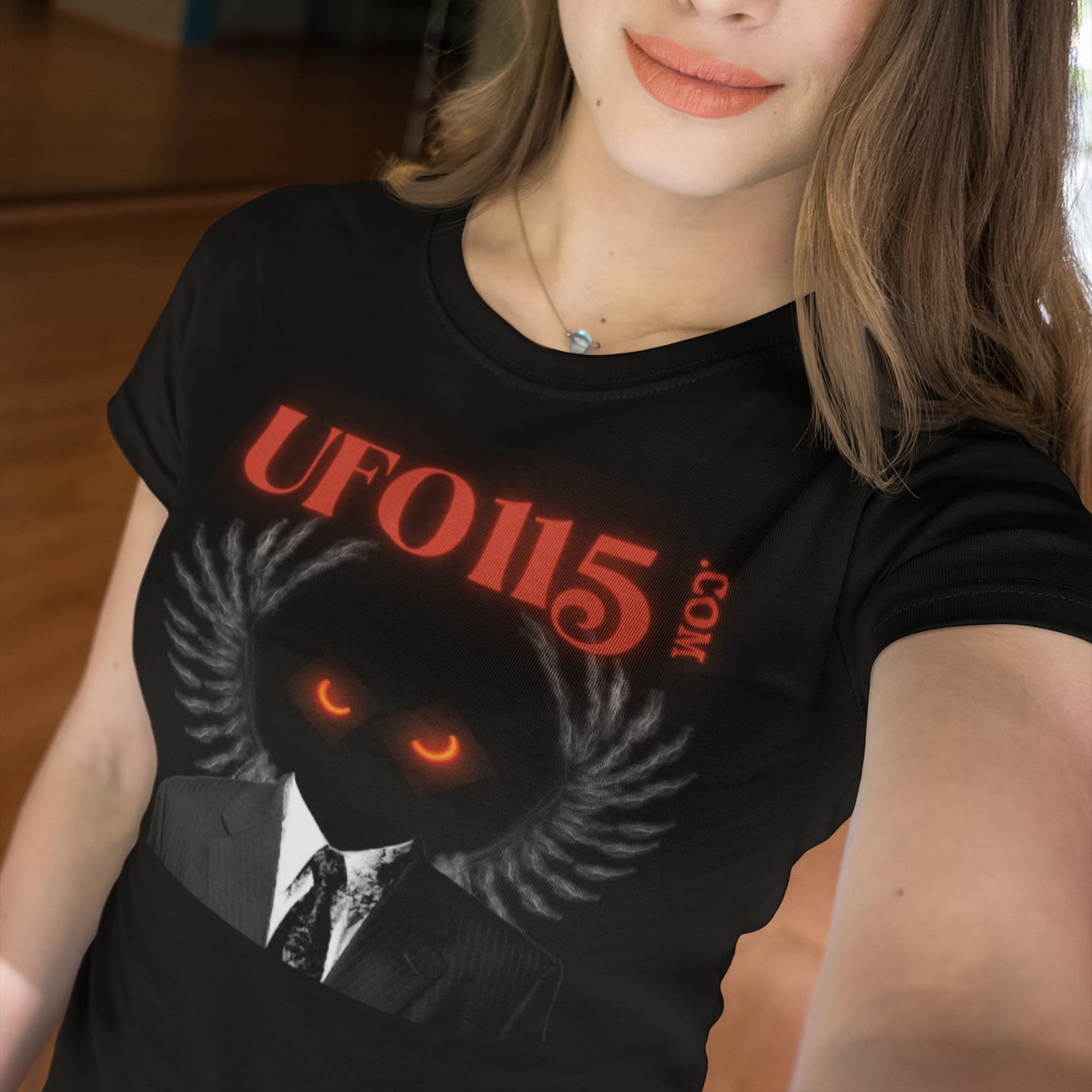 Model wearing the UFO115 Red Angel black T-shirt (front view)