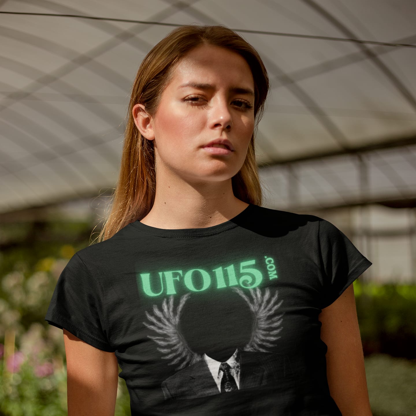 Model wearing the UFO115 Green Angel black T-shirt (front view)