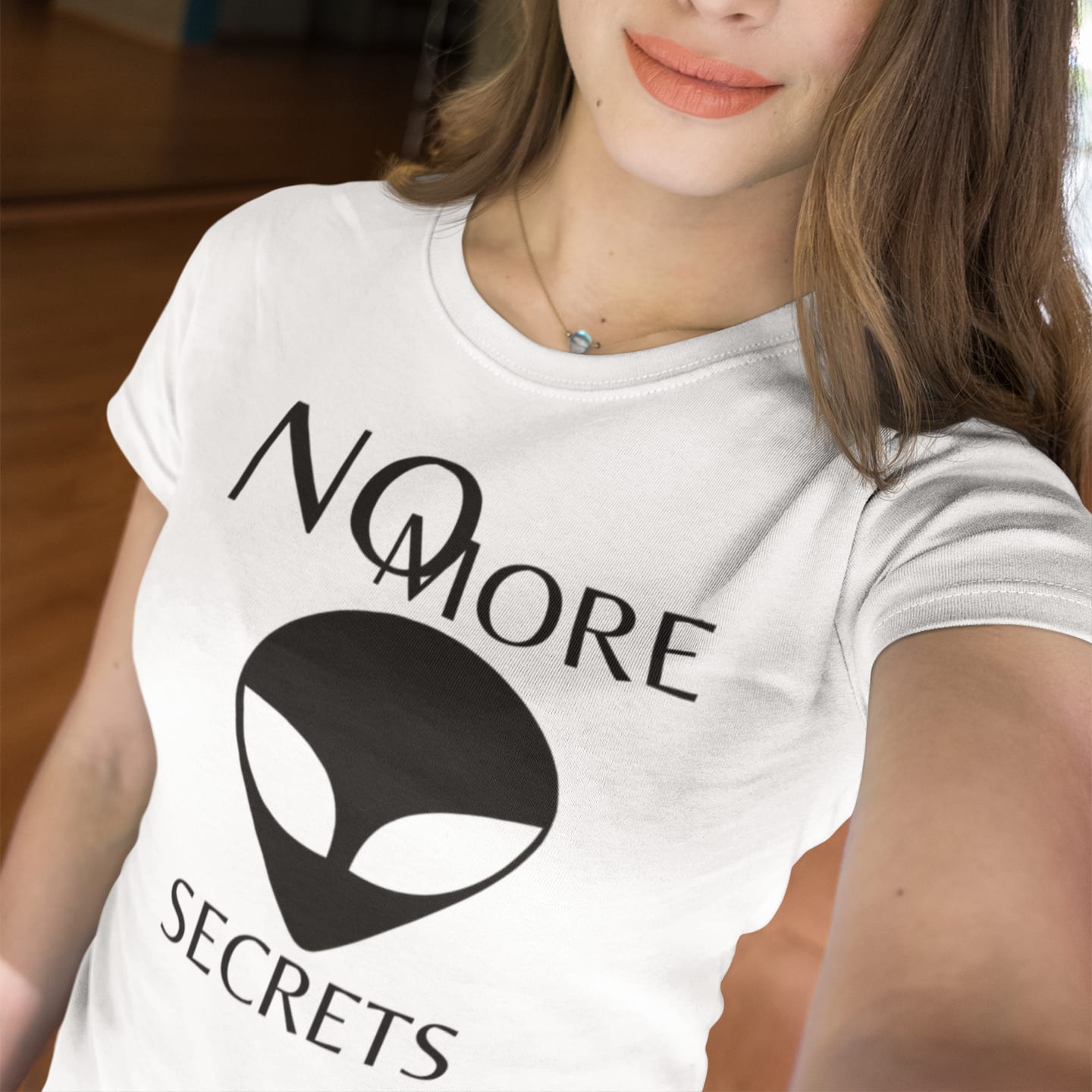 Model wearing the No More Secrets Black Alien Face white T-shirt (front view)