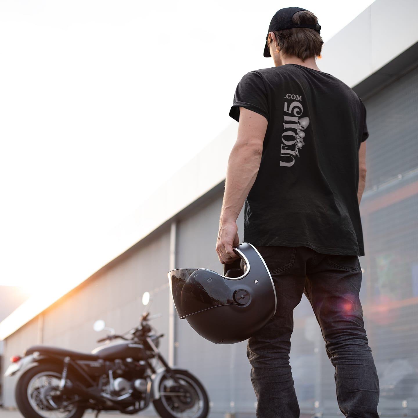 Model wearing the Uup 115 Entering Area 51 black T-shirt (back view, UFO115 back print)