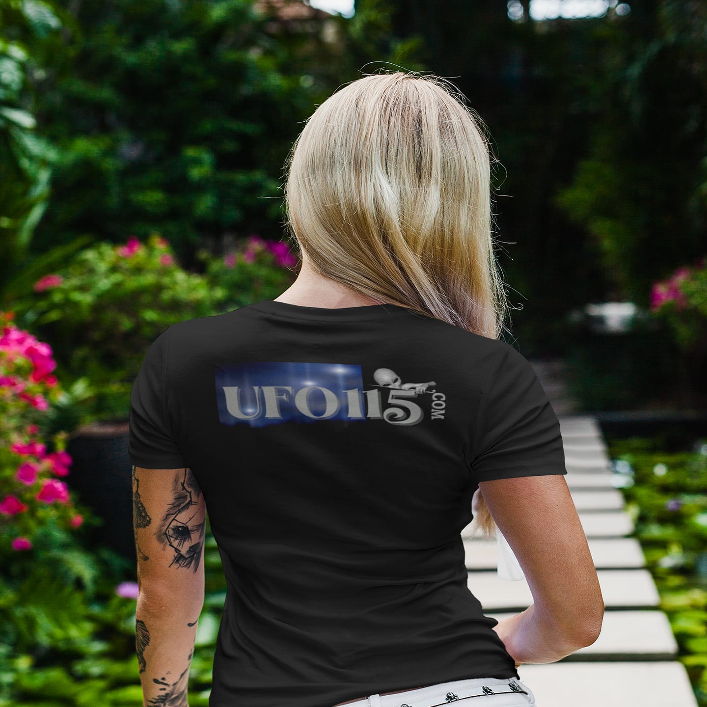 Model wearing the Area 51 Black Triangle black T-shirt (back view, UFO115 back print)