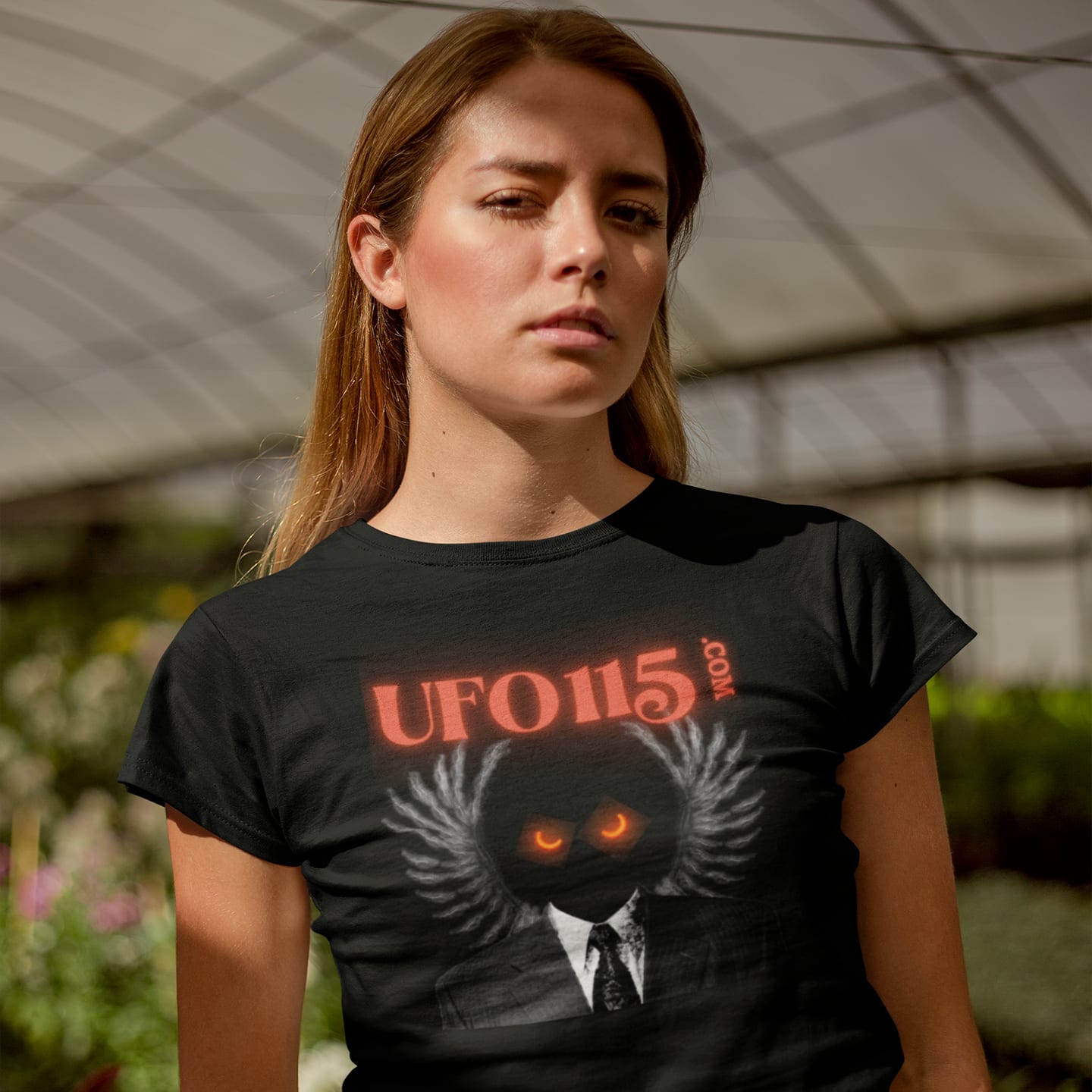 Model wearing the UFO115 Red Angel black T-shirt (front view)