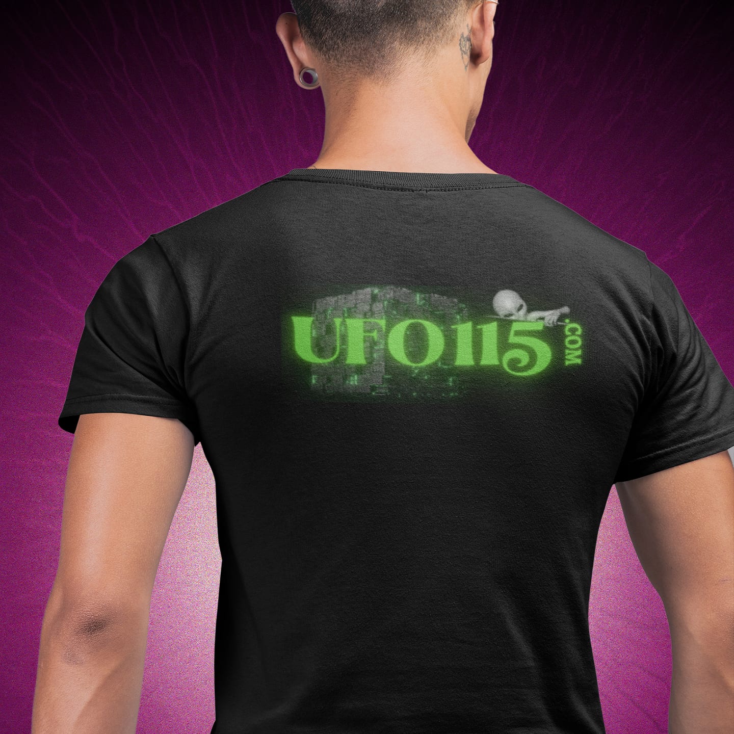 Model wearing the Government Denial Is Futile black T-shirt (back view, UFO115 back print)