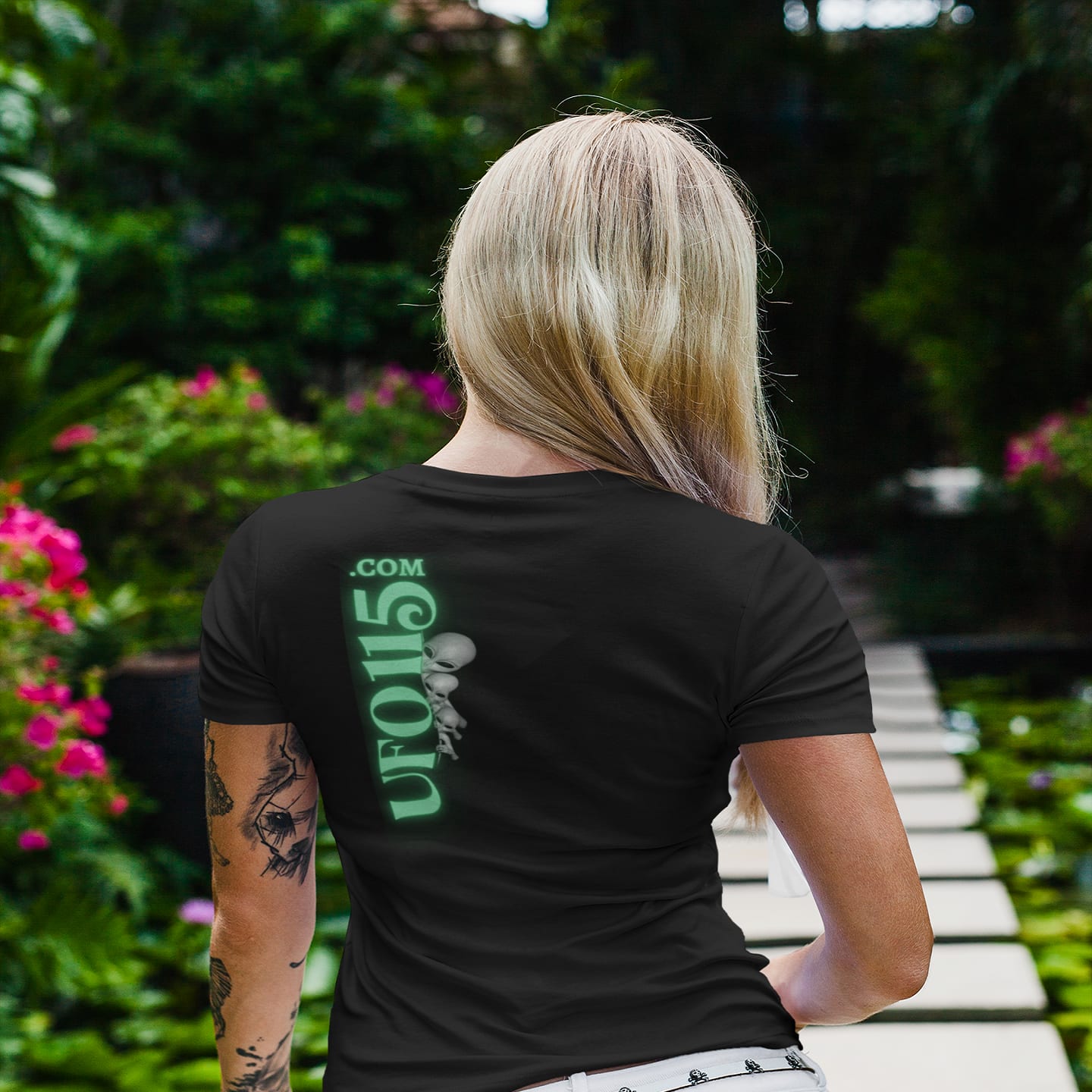 Model wearing the Element 115 Glowing Alien Grey black T-shirt (back view, UFO115 back print)
