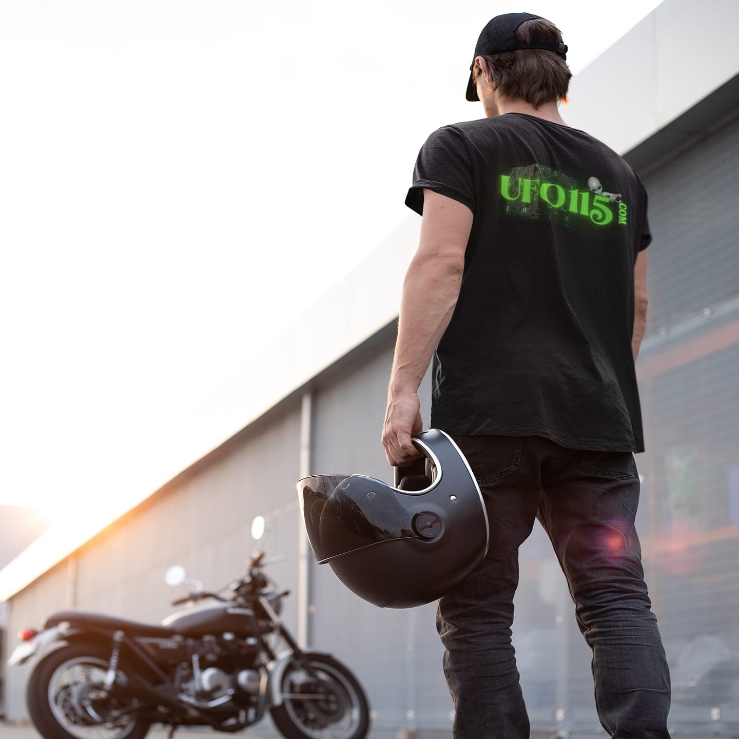 Model wearing the Government Denial Is Futile black T-shirt (back view, UFO115 back print)