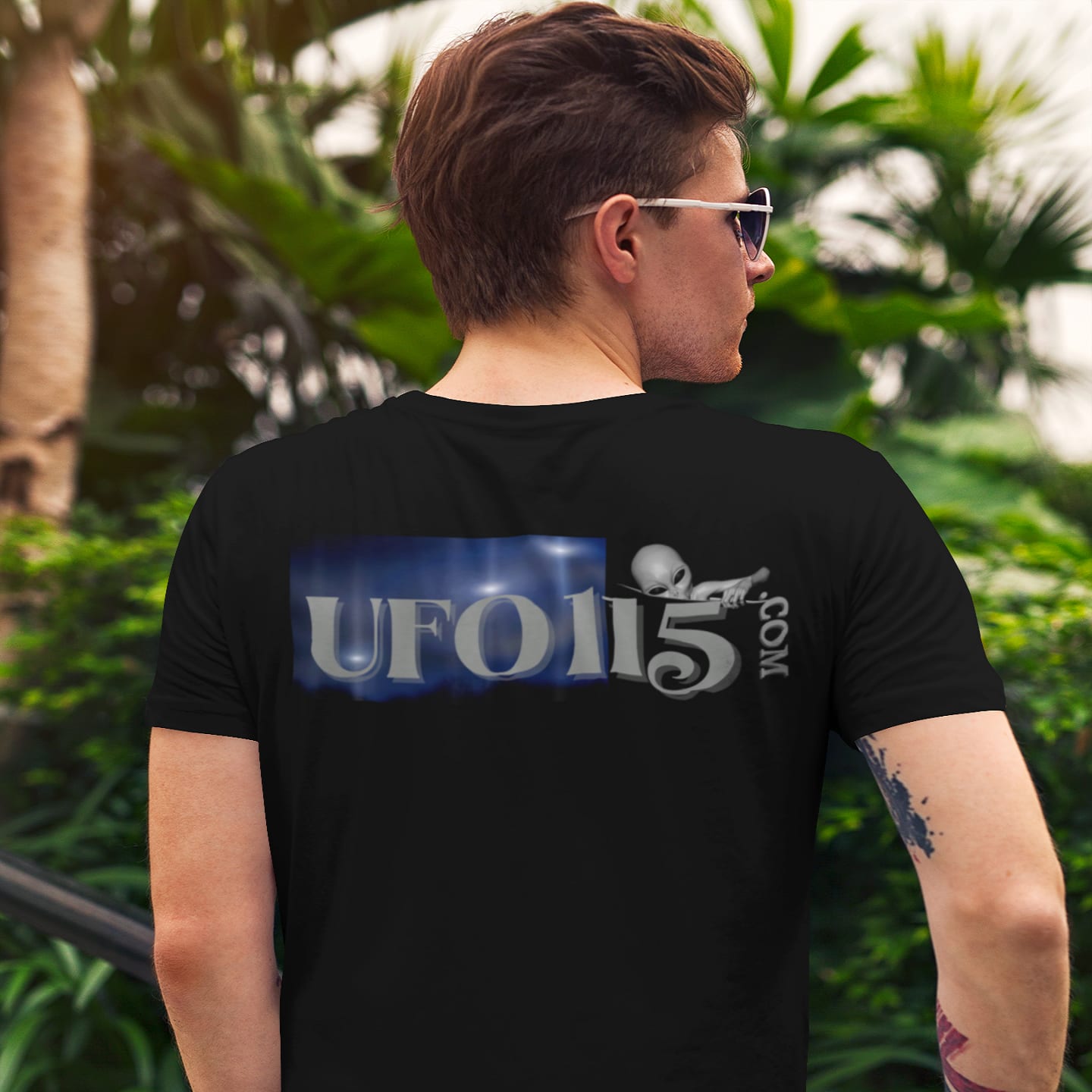 Model wearing the Area 51 Black Triangle black T-shirt (back view, UFO115 back print)