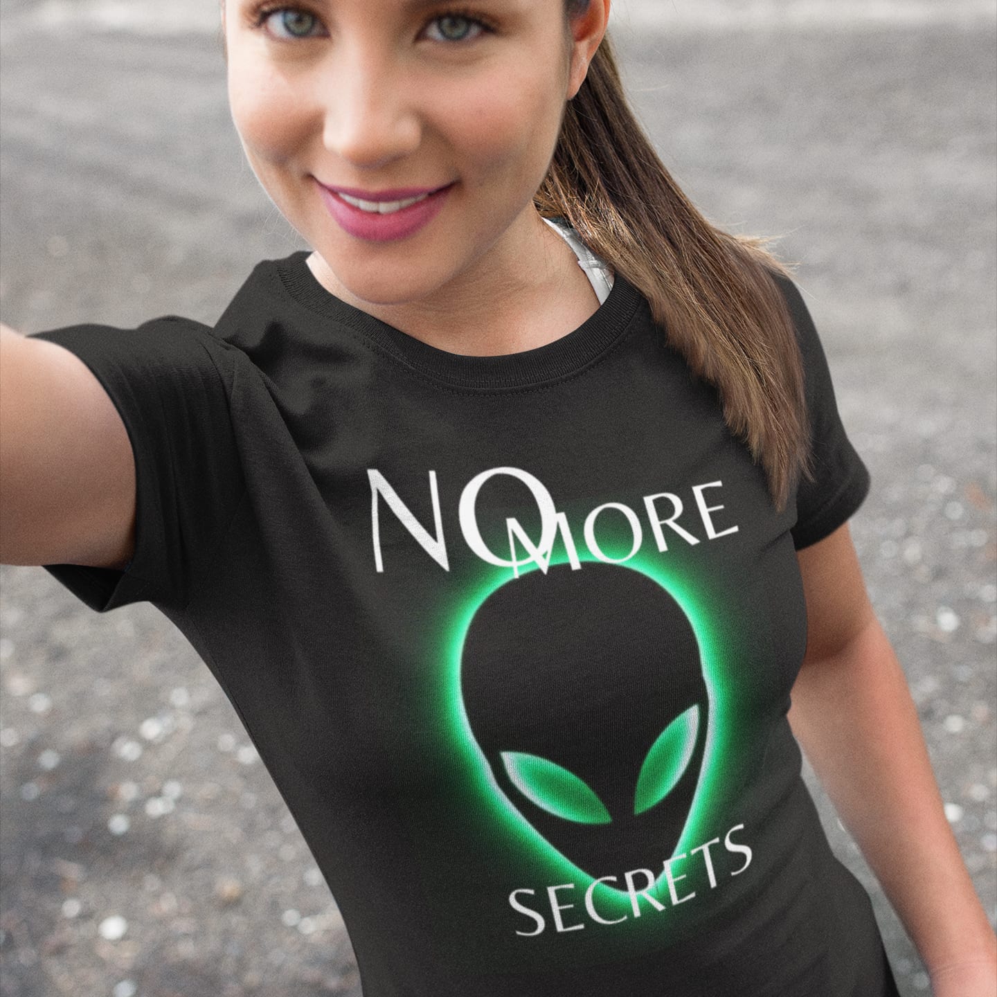 Model wearing the No More Secrets Green Glow Alien Face black T-shirt (front view)